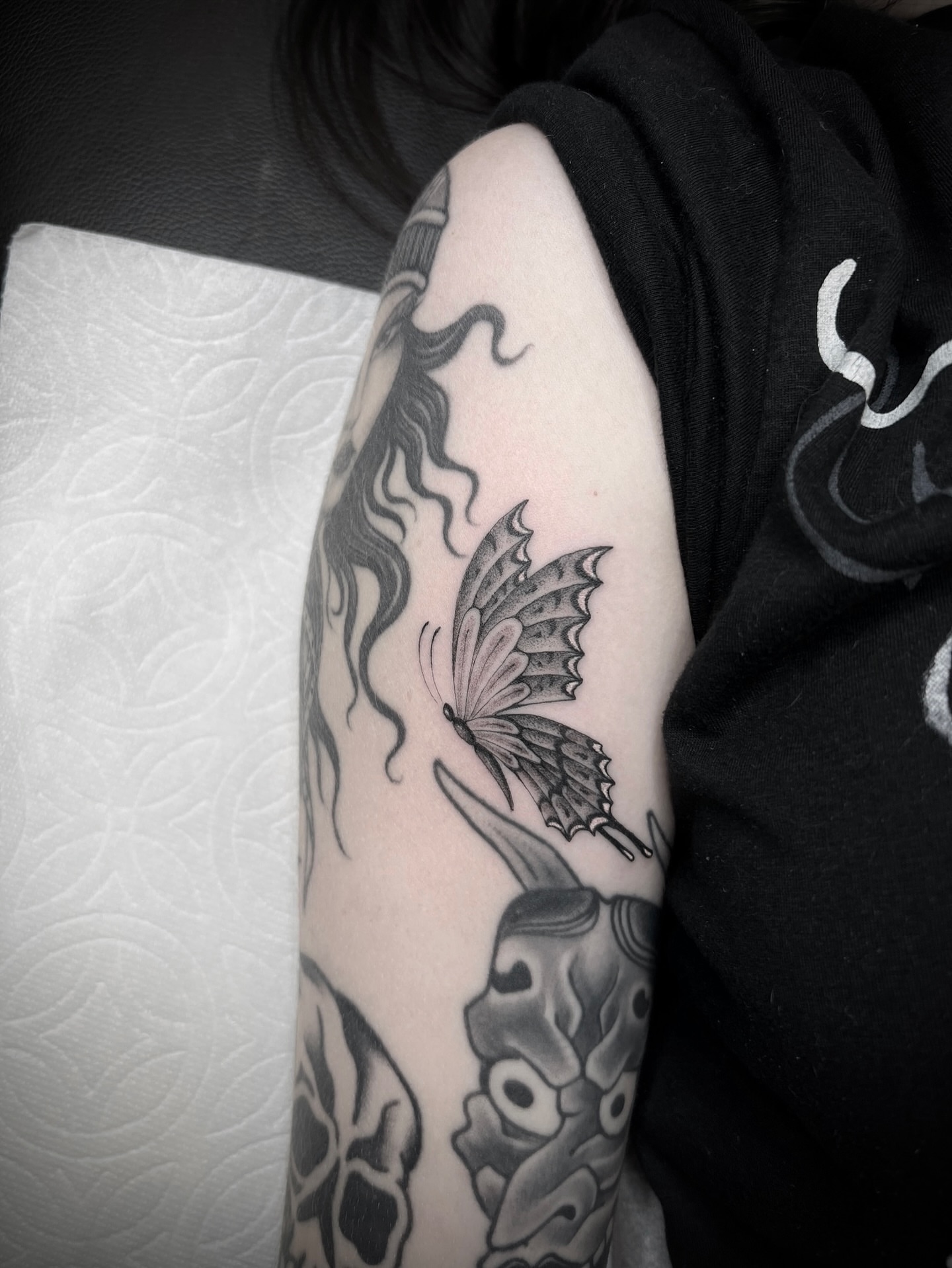 Butterfly black and grey tattoo on the forearm by Valerie Dominguez