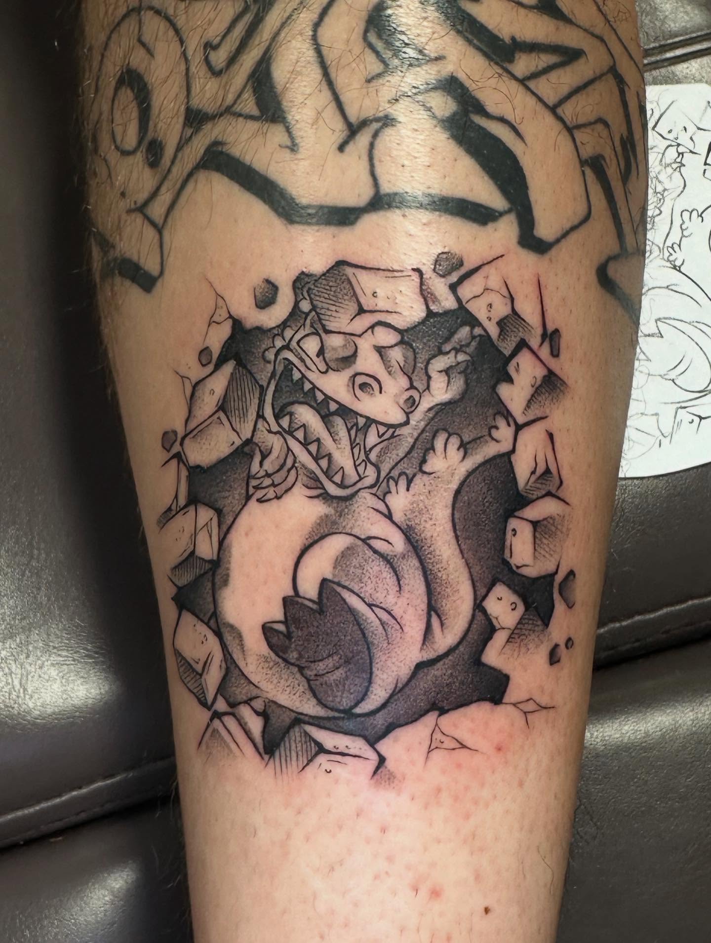 Dinosaur breaking through wall black and grey tattoo on the forearm by Jan Xander