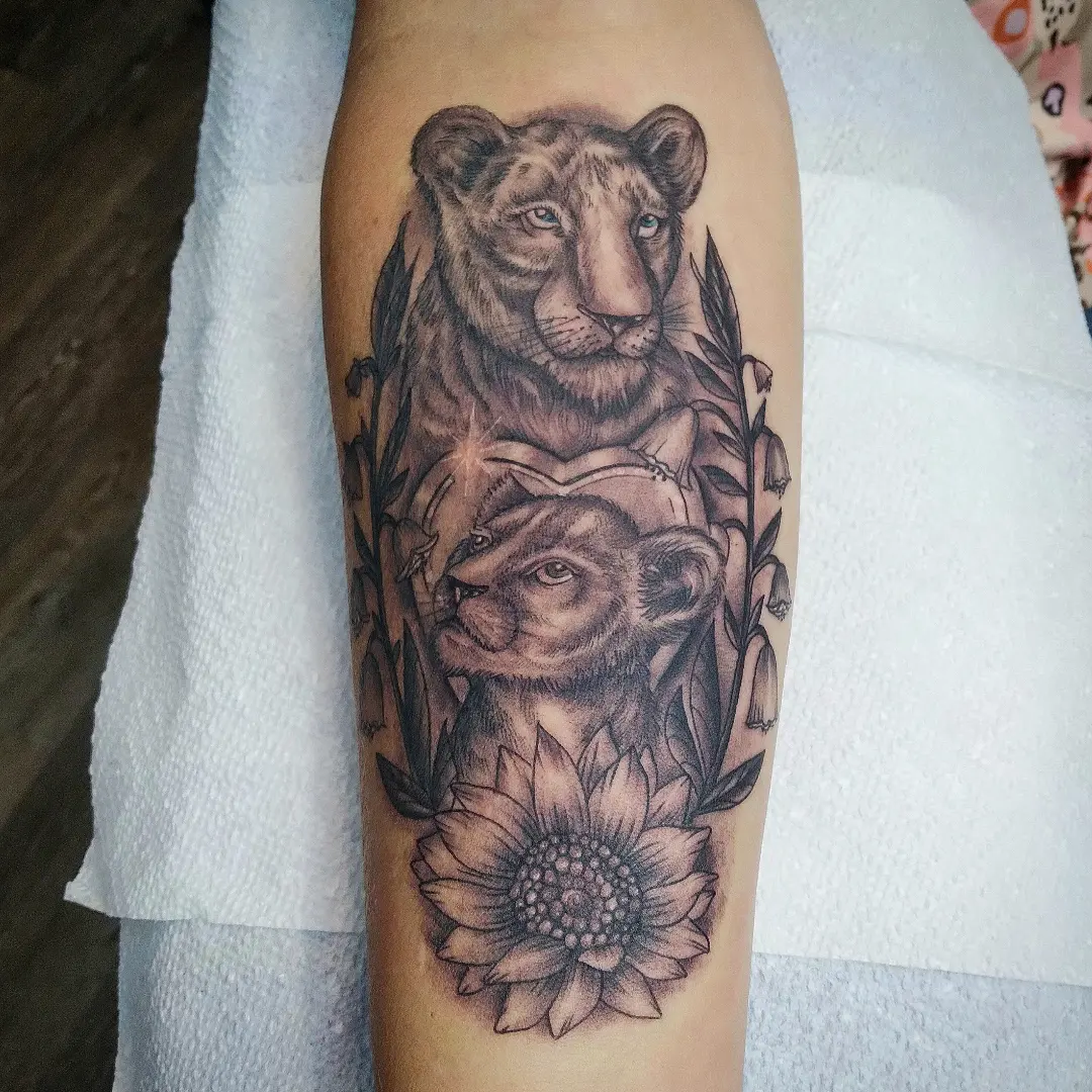 Lioness and cub realism tattoo on the forearm by Josh Sroga
