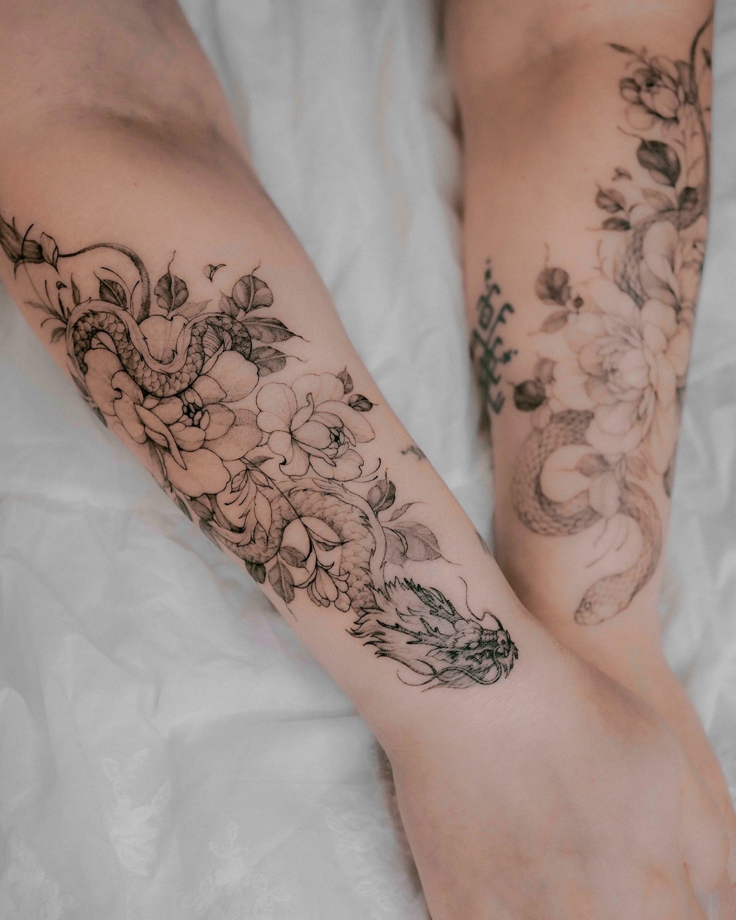 Snake and peony black and grey tattoo on the forearm by Yeonji