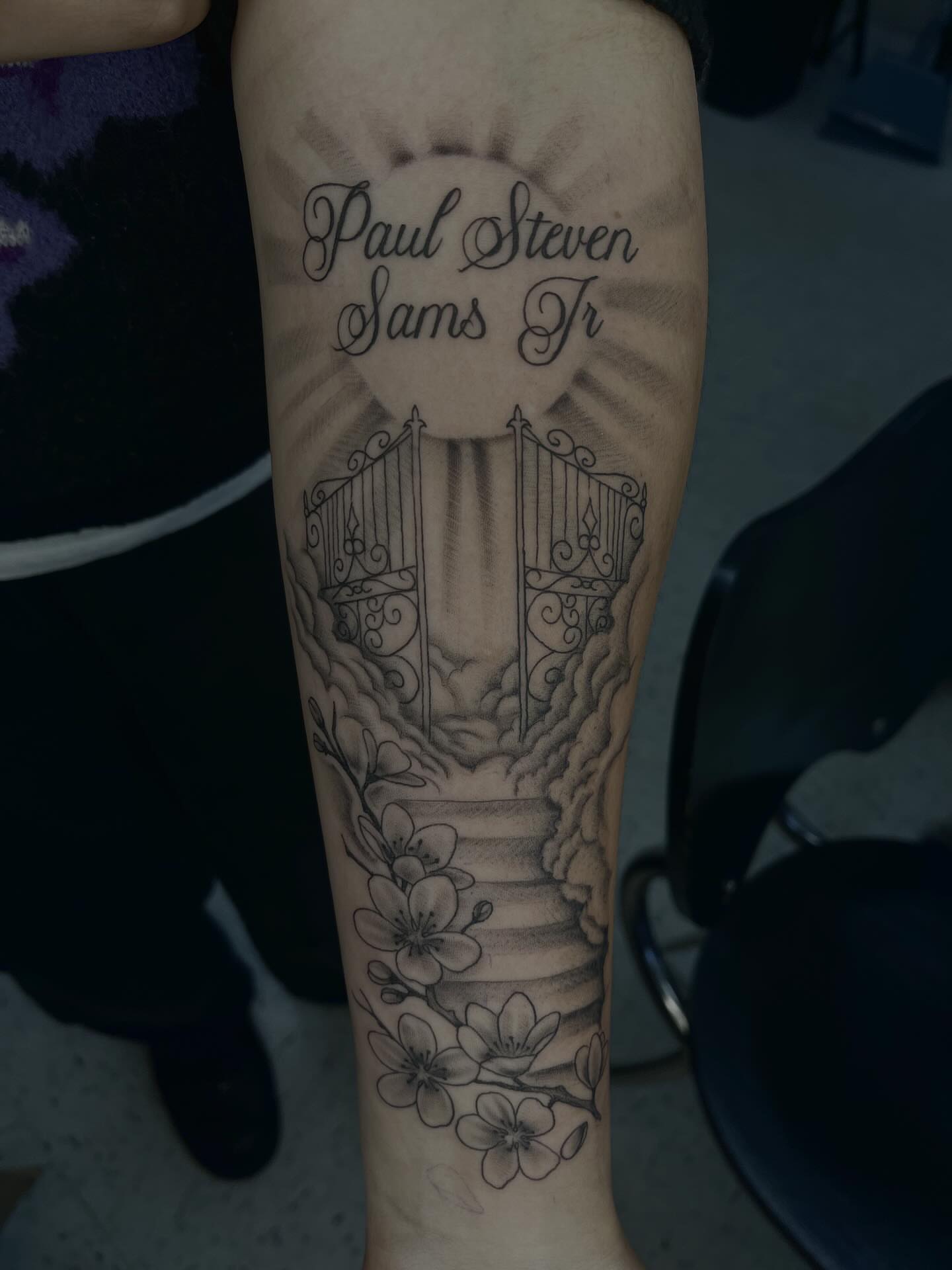 Gate and flowers black and grey tattoo on the forearm by Kenzie Kirk