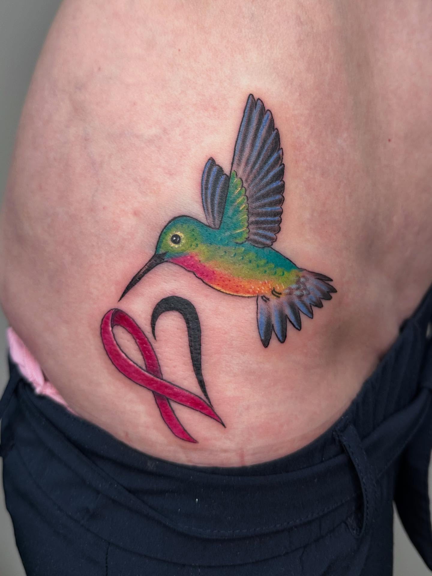 Hummingbird and ribbon realism tattoo on the thigh by Heather Tattoos Danvers MA
