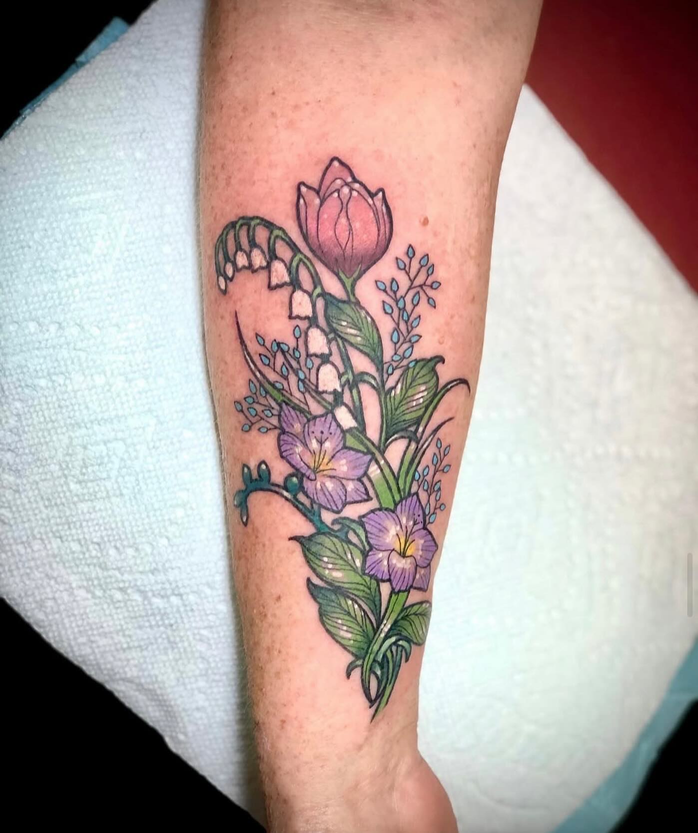 Floral arrangement new school tattoo on the forearm by Shayna Soderstrom, Columbus, Ohio