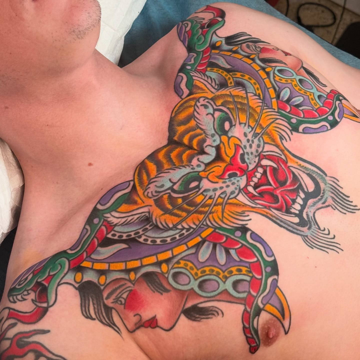 Tiger and woman American traditional tattoo on the chest by Jhon