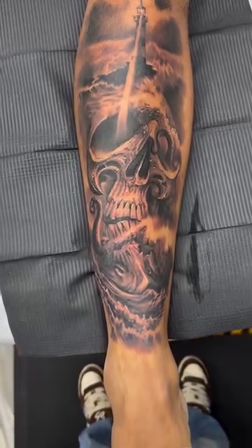 Skull with clouds and a cross realism tattoo by Steve Bishov