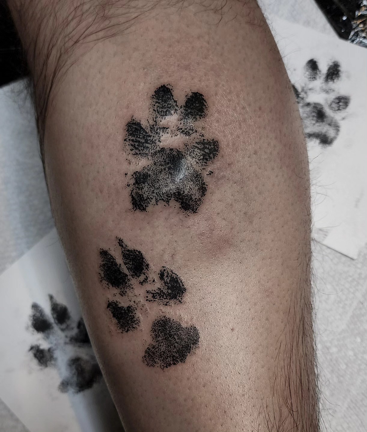 Paw prints dotwork tattoo on the forearm by Mariah Giovanna Hodgens