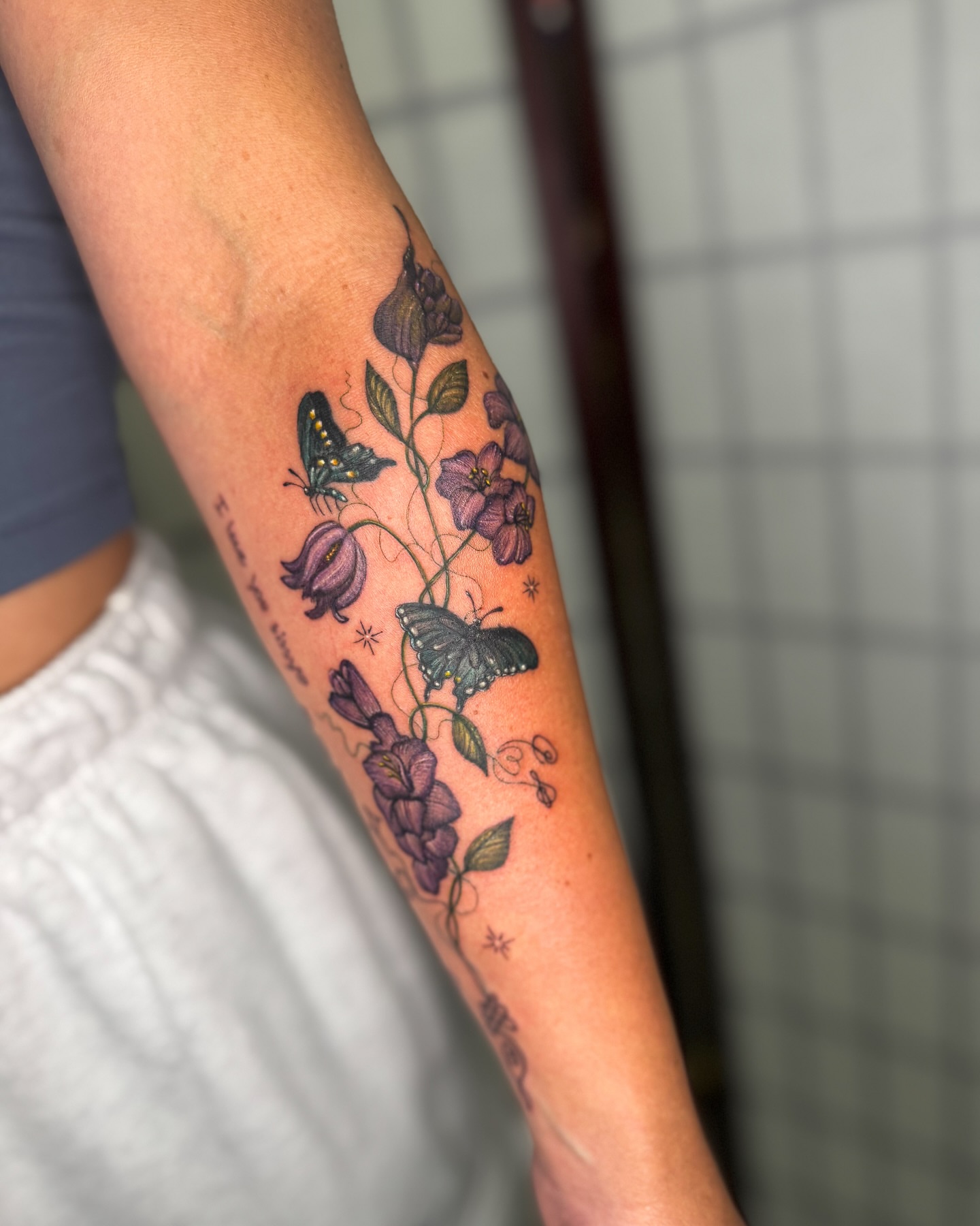 Flowers and butterflies realism tattoo on the forearm by Natasha Rachel Fineline Tattoos Nashville
