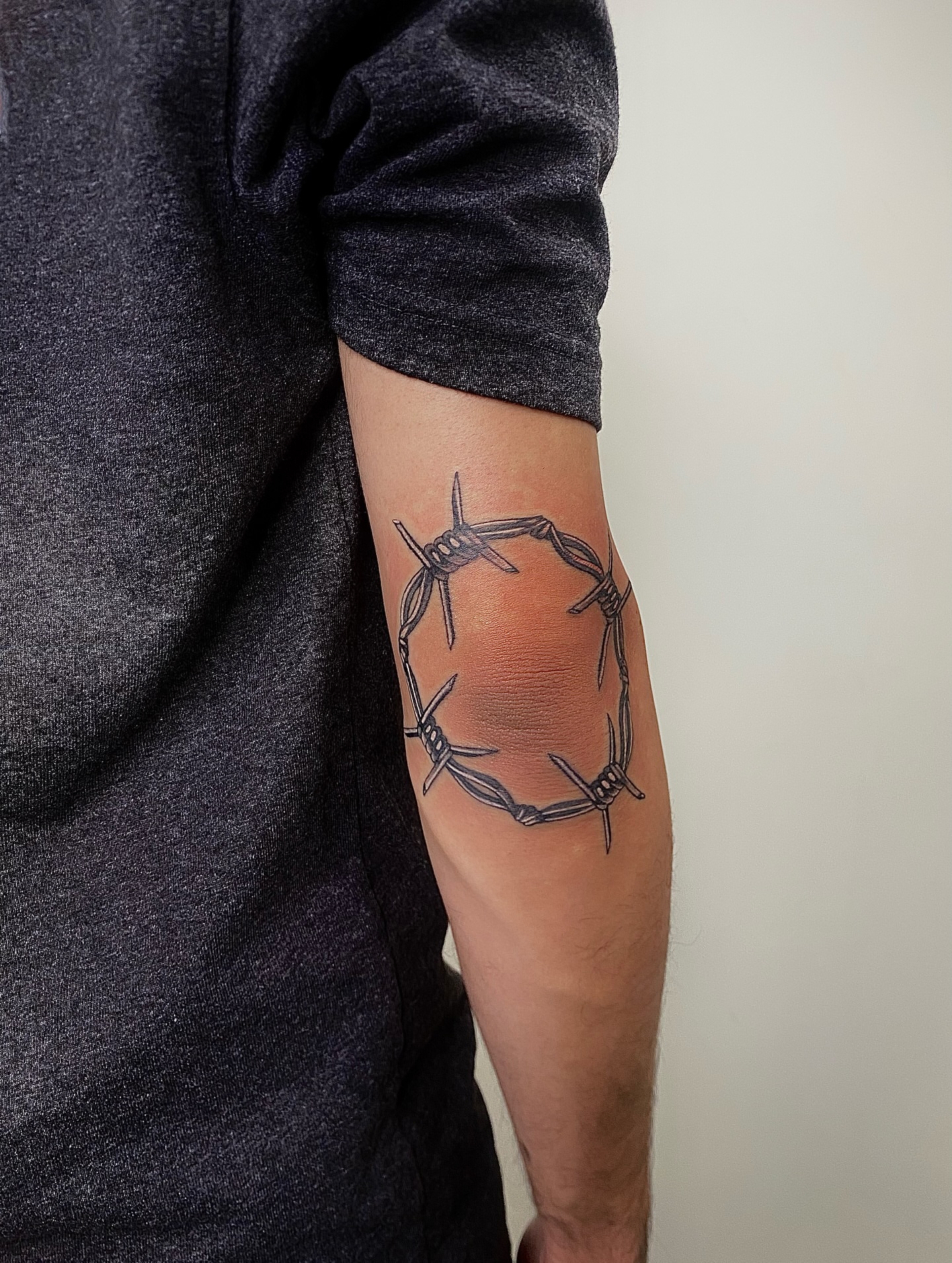 Barbed wire black and grey tattoo on the forearm by @tattotos