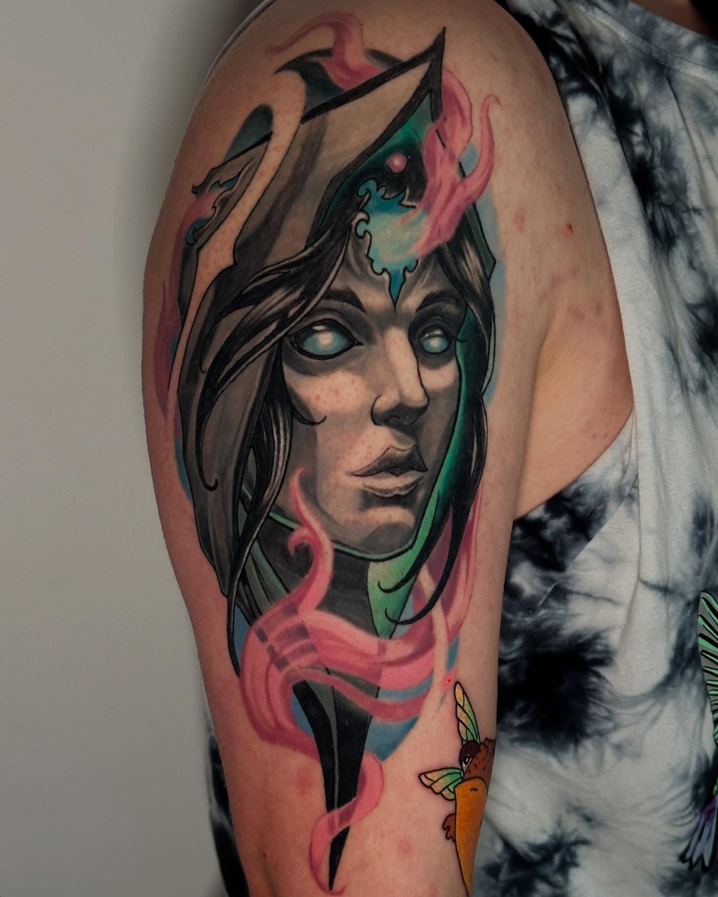 Woman with flames realism tattoo on the shoulder by Zoe "Z" Fisk