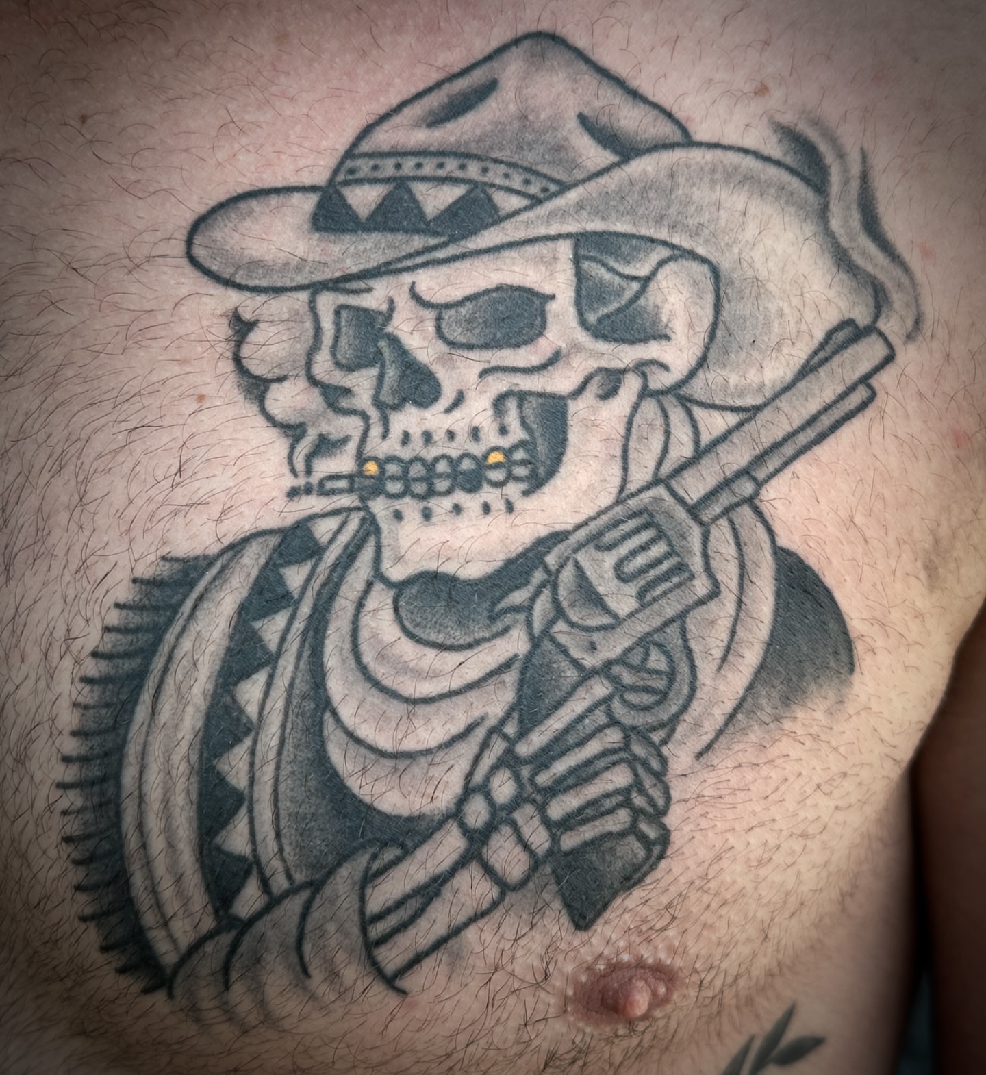 Skull with rifle black and grey tattoo on the chest by Chris Blanchard