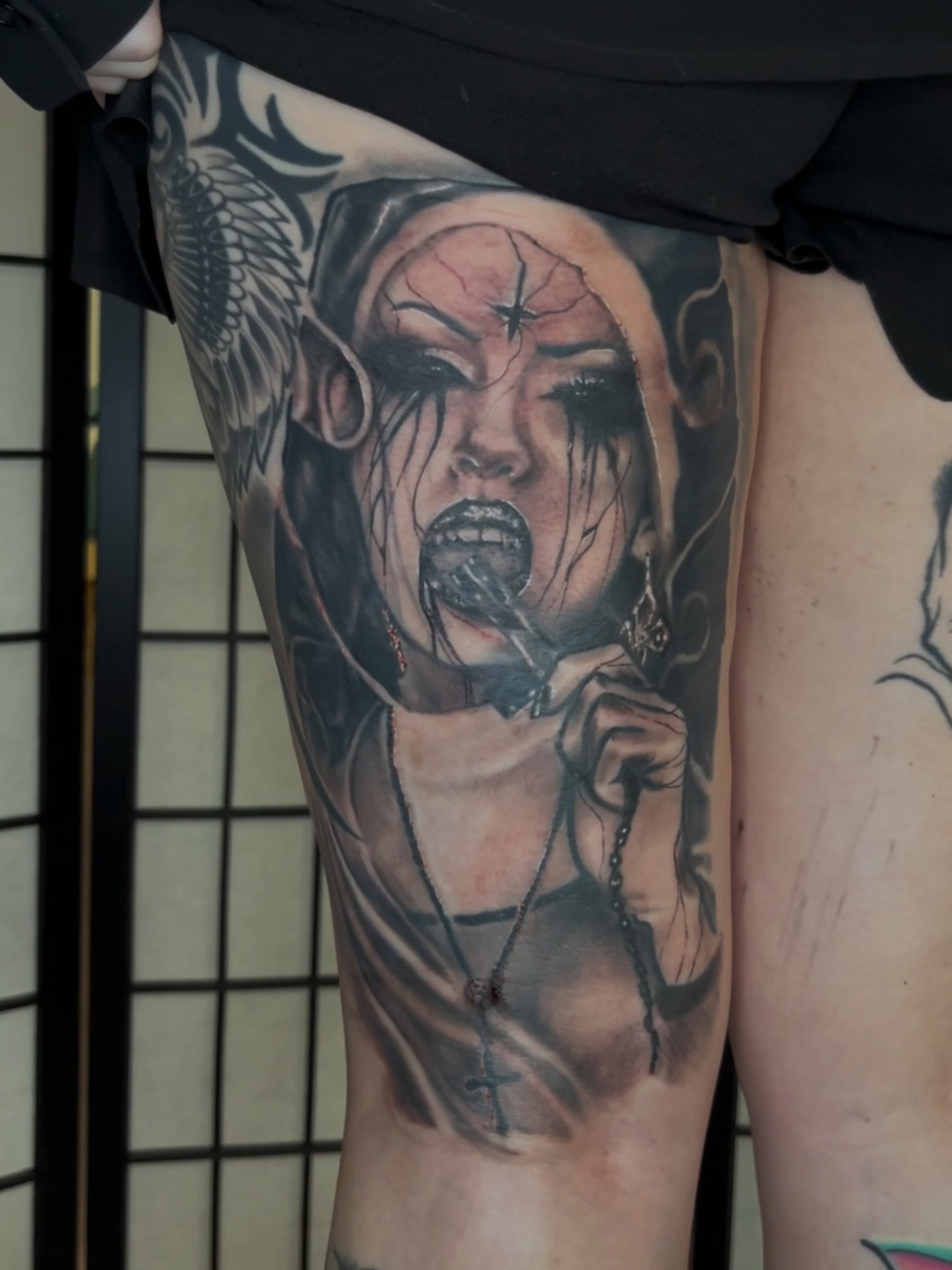 Angry nun realism tattoo on the thigh by C.J. Rued