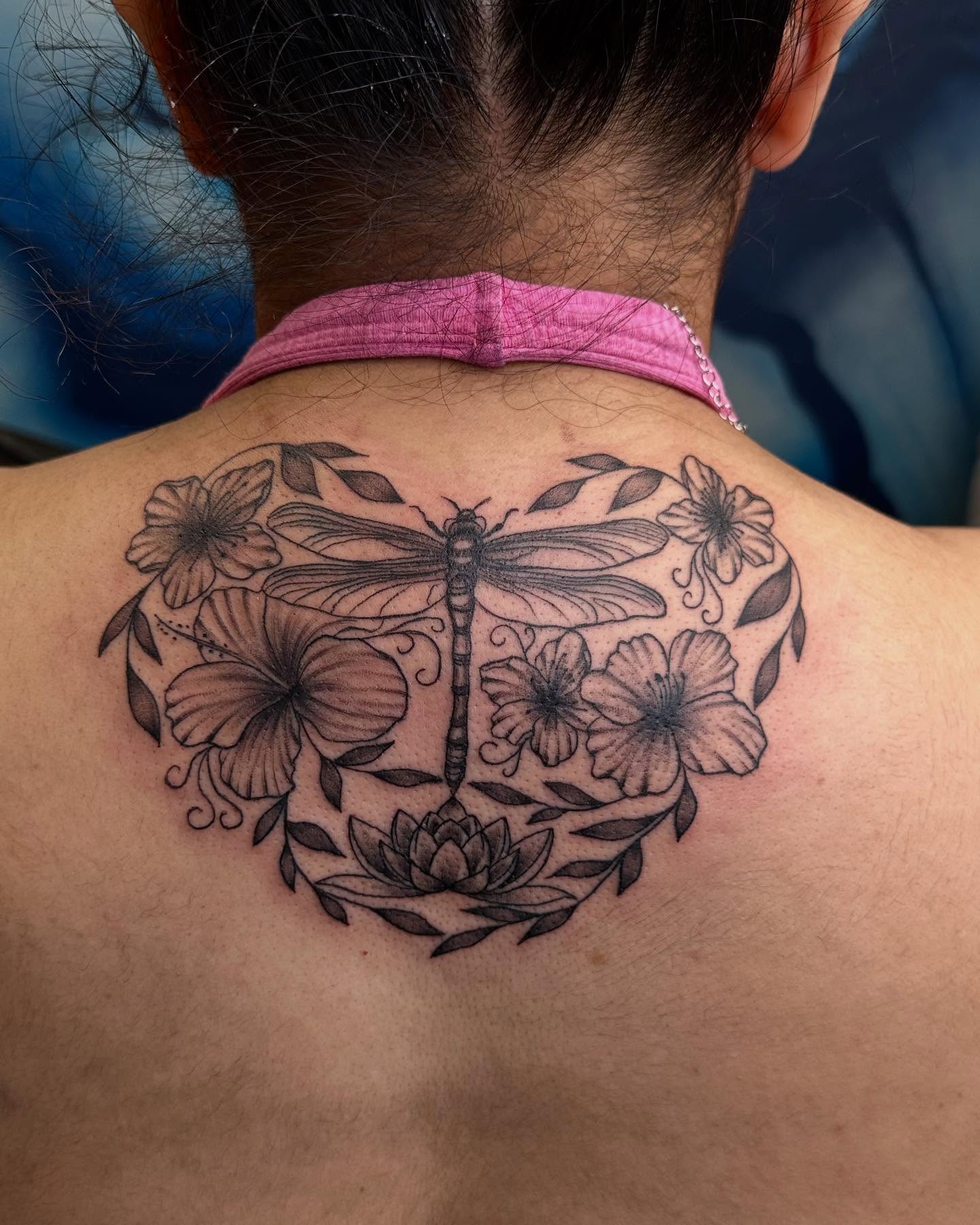 Dragonfly and flowers black and grey tattoo on the back by Kimberly landin