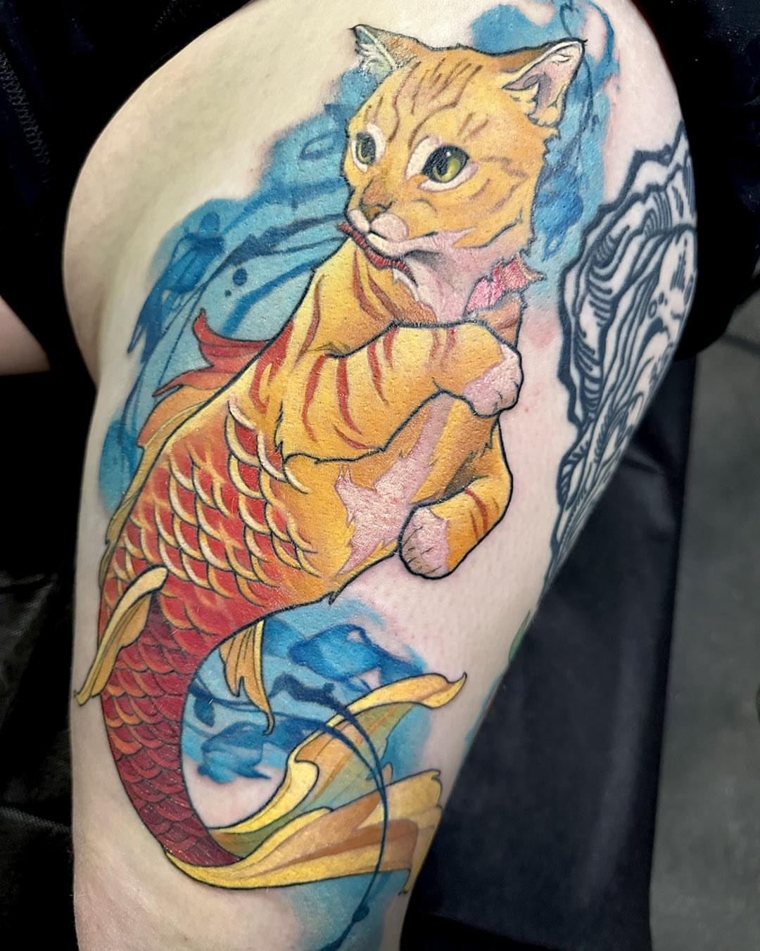 Cat with fish tail watercolor tattoo on the forearm by Harper Clark