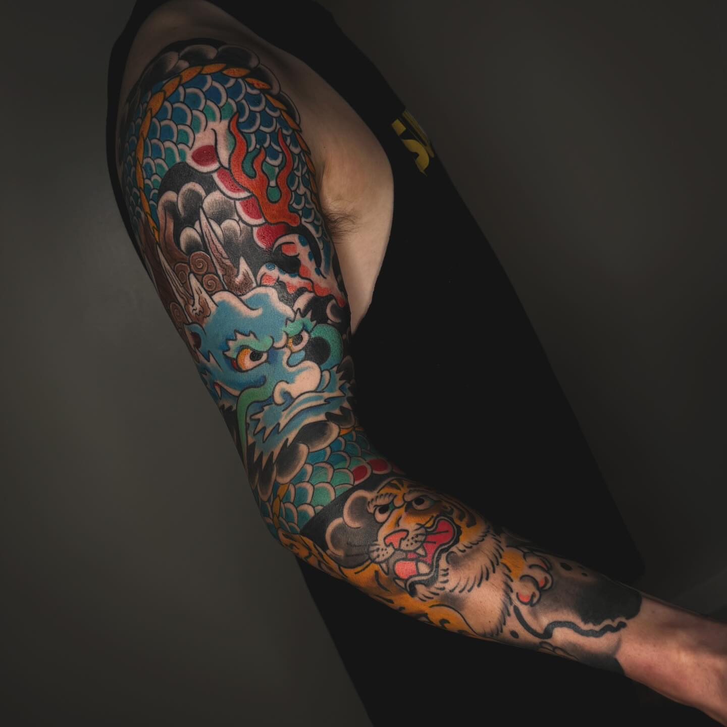 Dragon and tiger japanese irezumi tattoo on the upper arm by Liz Mercer ★ Tattooer - Raleigh NC