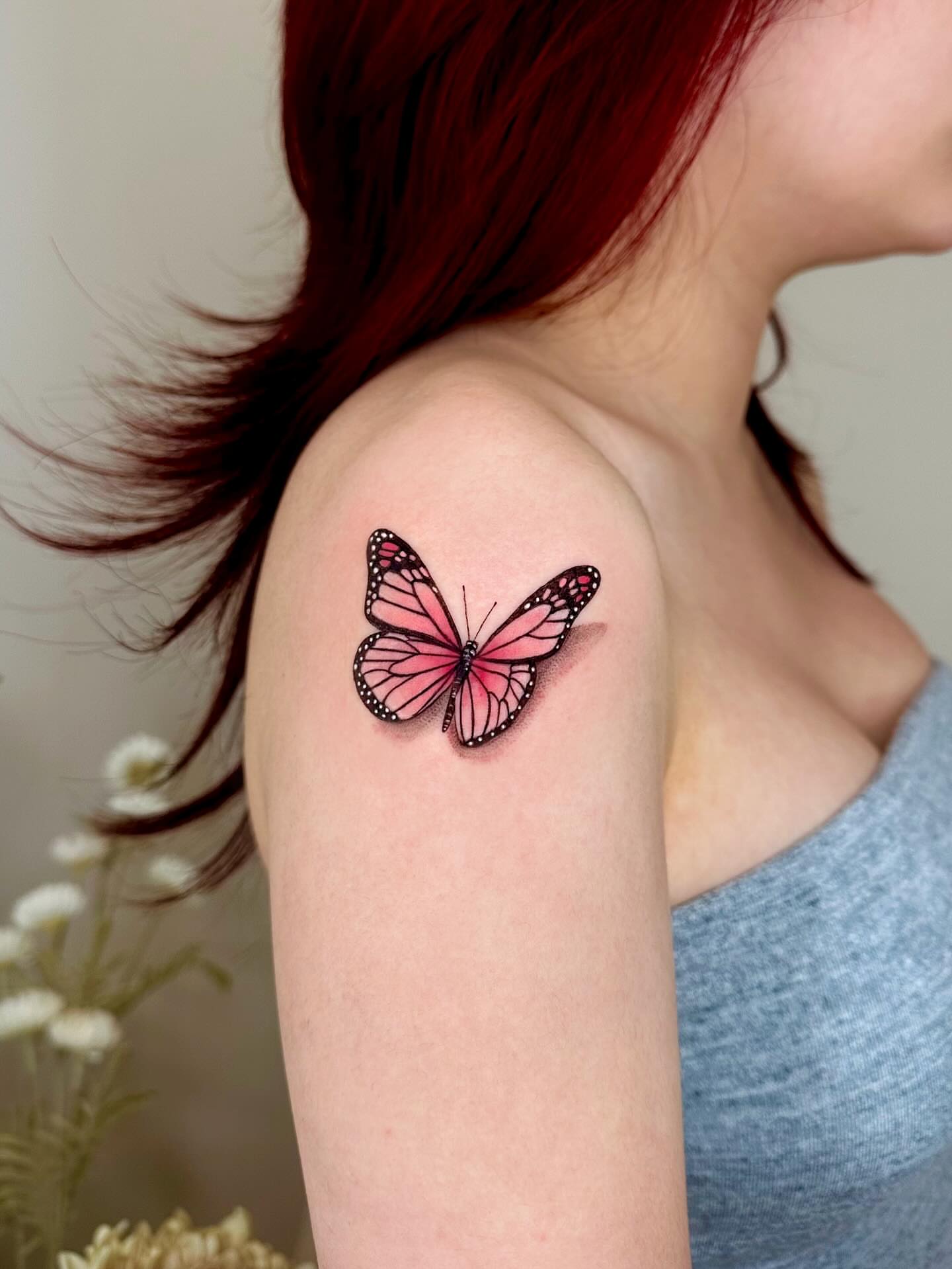 Butterfly realism tattoo on the upper arm by Claire