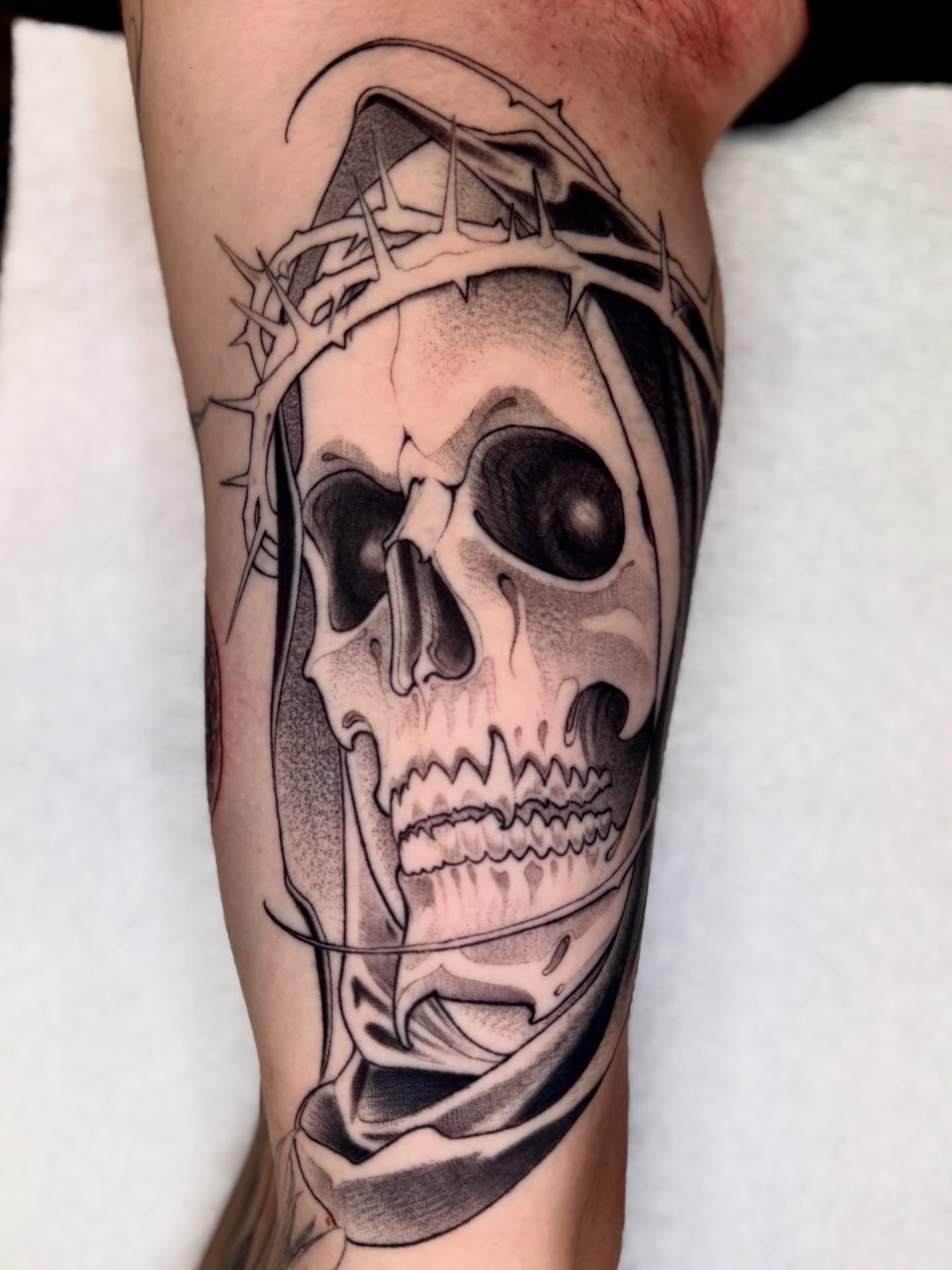 Skull with crown of thorns realism tattoo on the forearm by Angelo Buonanno, Las Vegas, Nevada