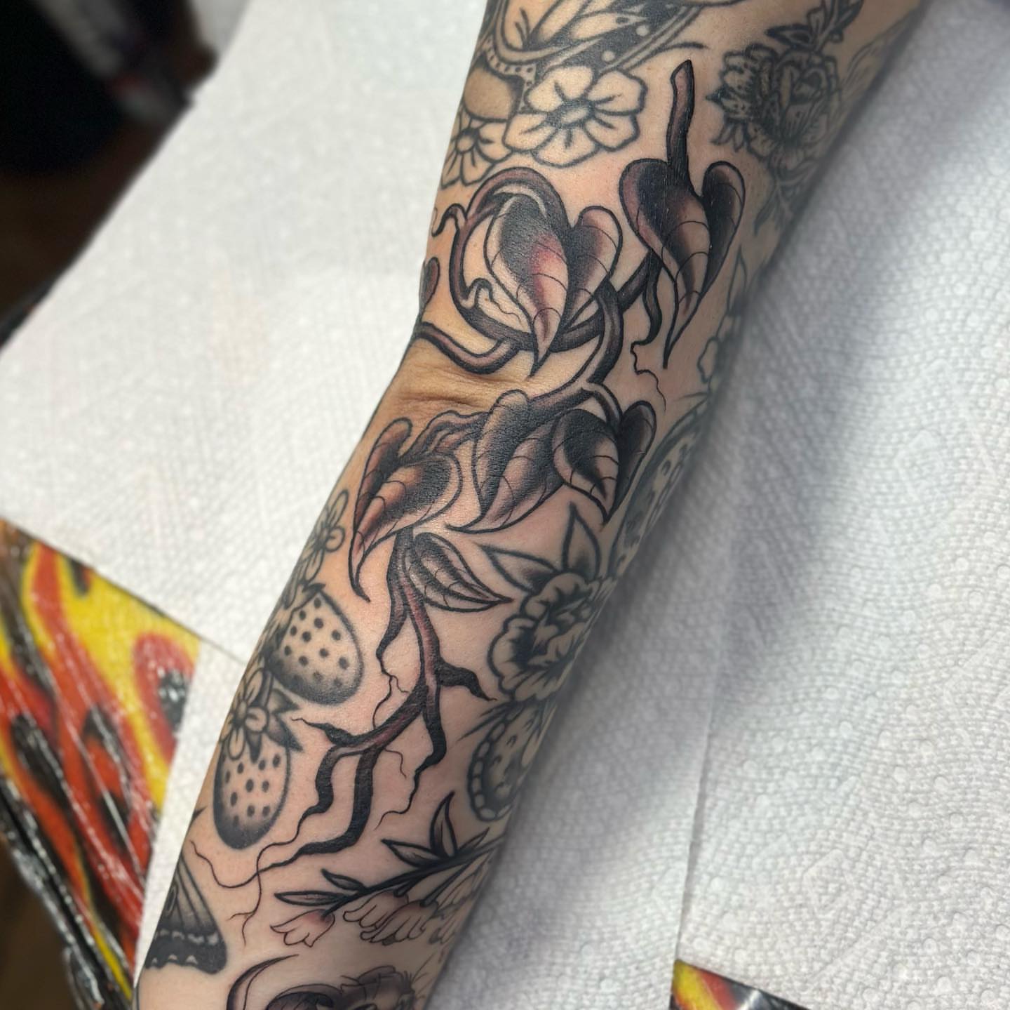 Floral arrangement American traditional tattoo on the forearm by Alexa Wolfkiel