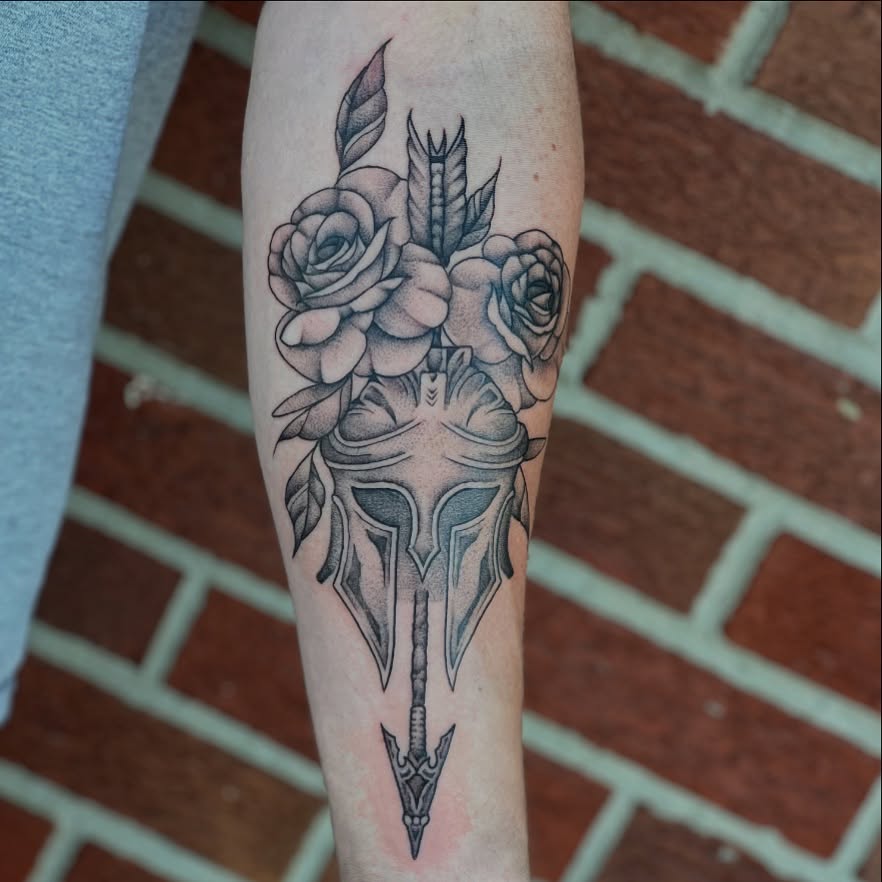 Spartan helmet with roses realism tattoo on the forearm by Dani McBay