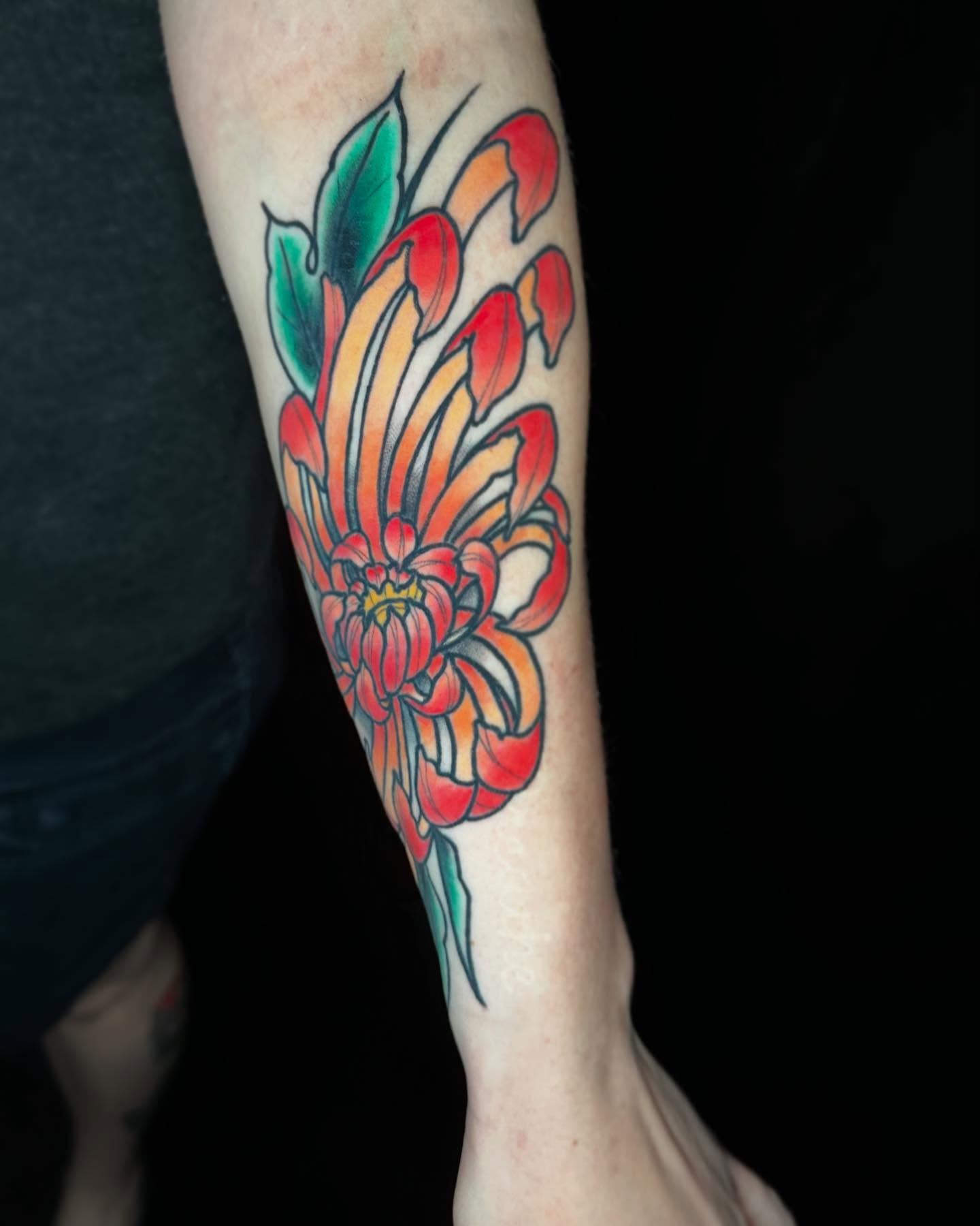 Chrysanthemum American traditional tattoo on the forearm by John Milosh Chamberlin