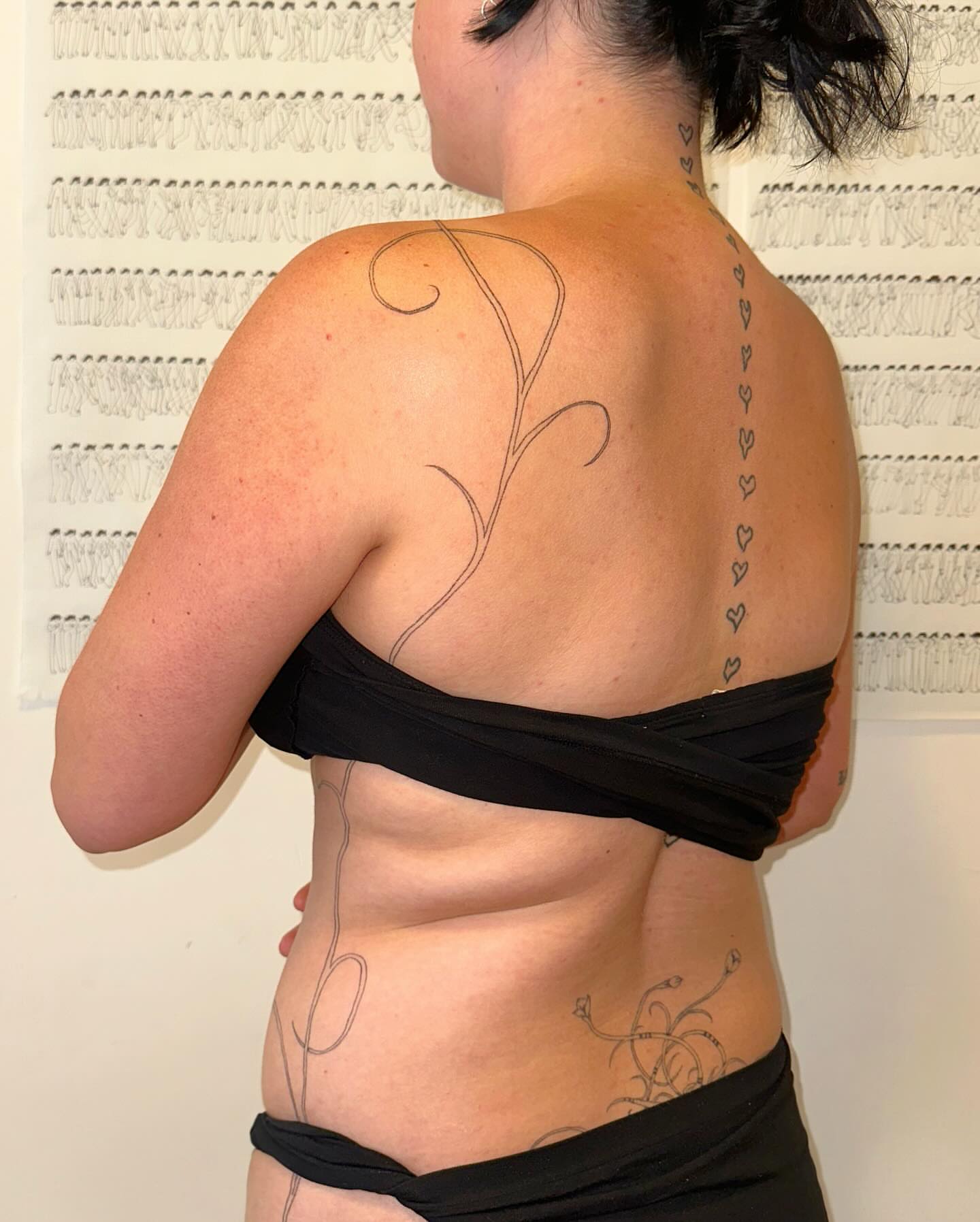 Floral vine fine line tattoo on the back by kate