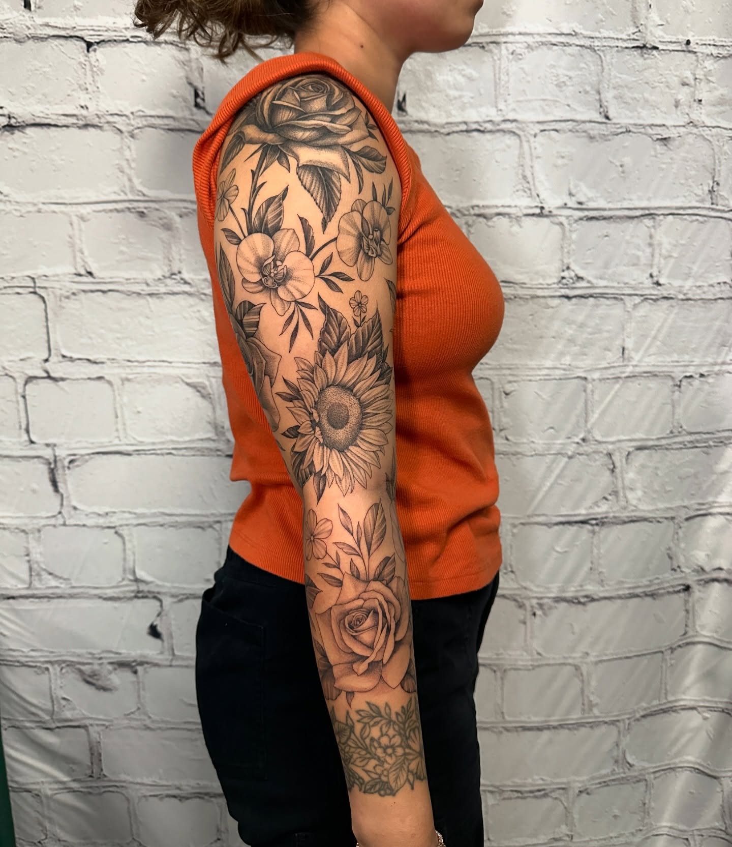 Floral bouquet black and grey tattoo on the upper arm by Stephen Hansen