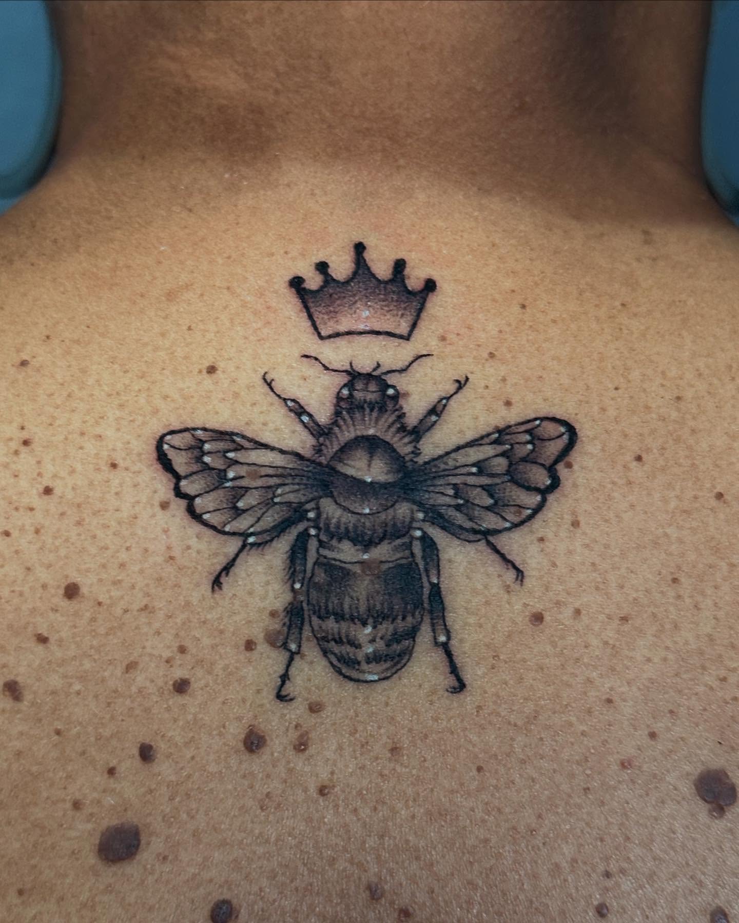 Bee with crown black and grey tattoo on the chest by Taylin Johnson- Illustrative Blackwork, Columbus, Ohio