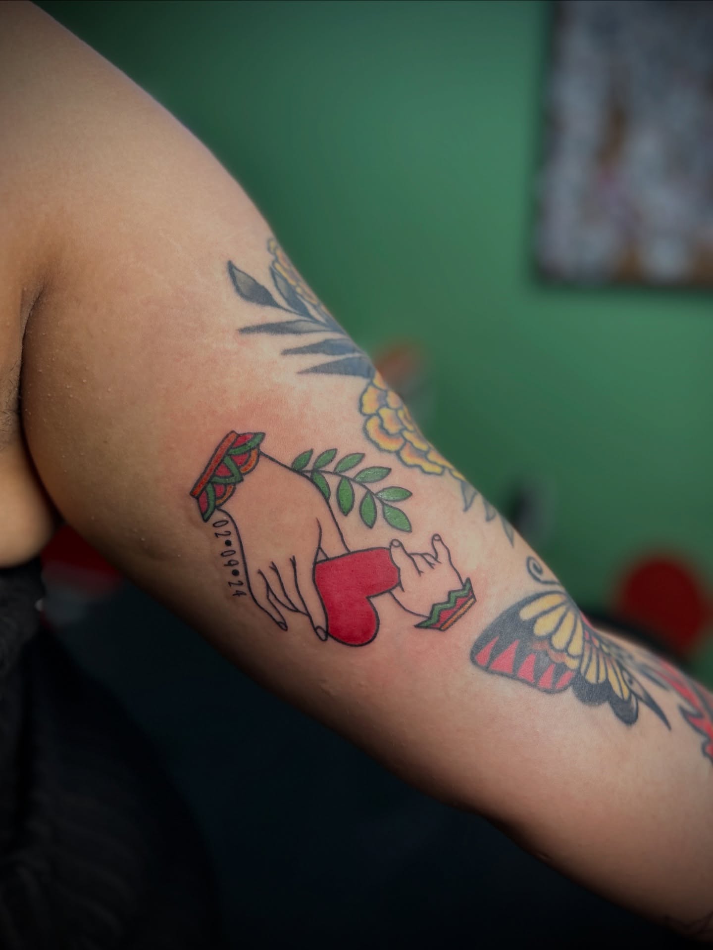 Heart and hand gesture American traditional tattoo on the forearm by Kiersten Tickle