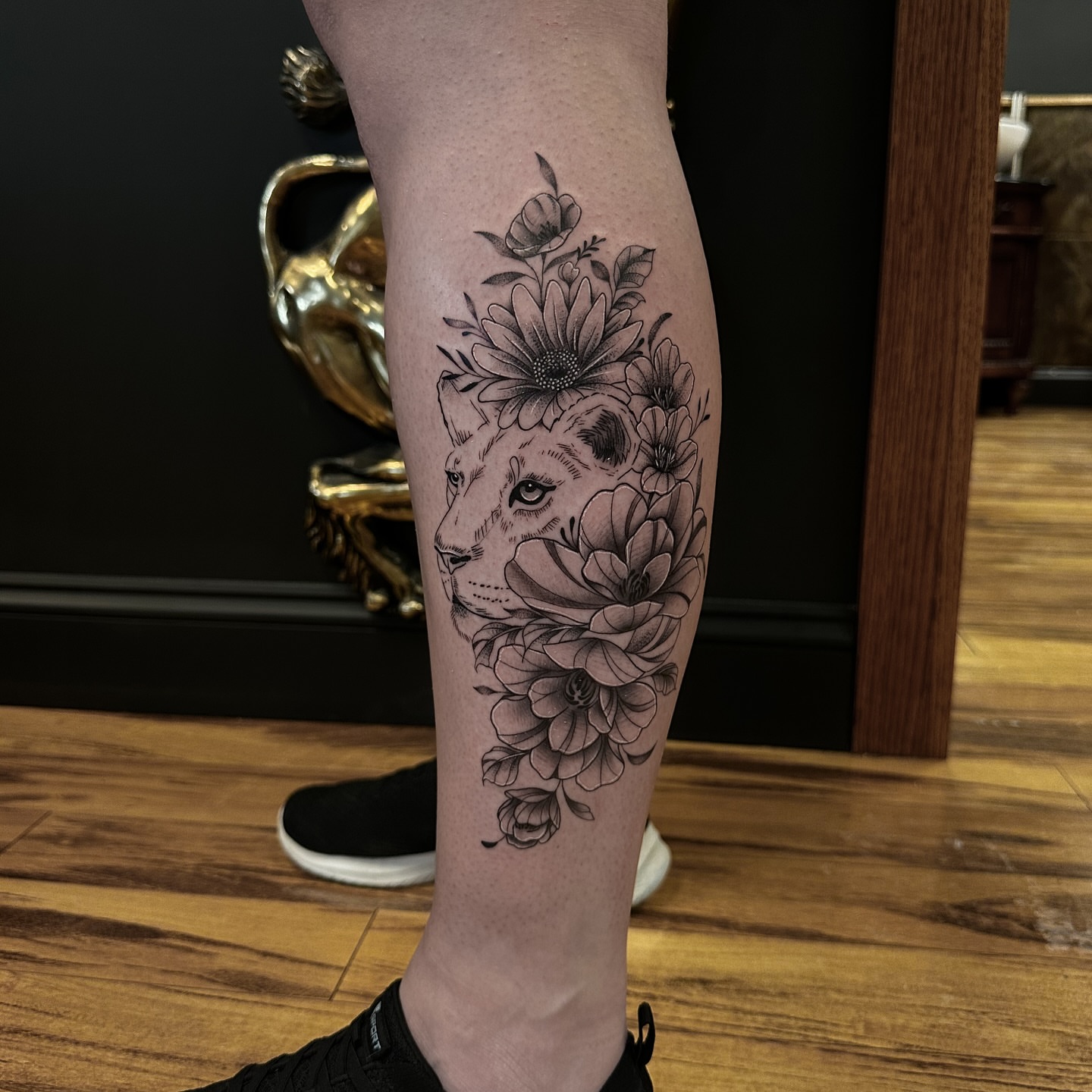 Lion with floral crown realism tattoo on the forearm by Leo Fernandes, Danvers, Massachusetts