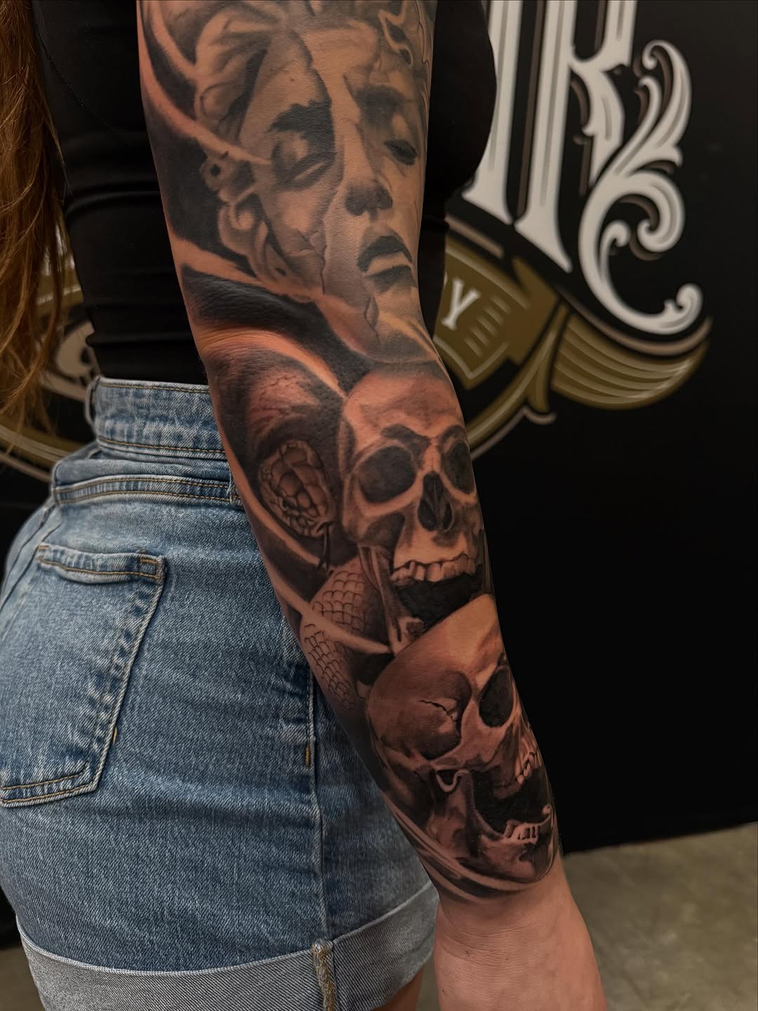Skulls and snake with statue realism tattoo on the forearm by Danny Aceves ✨ San Diego tattoo artist