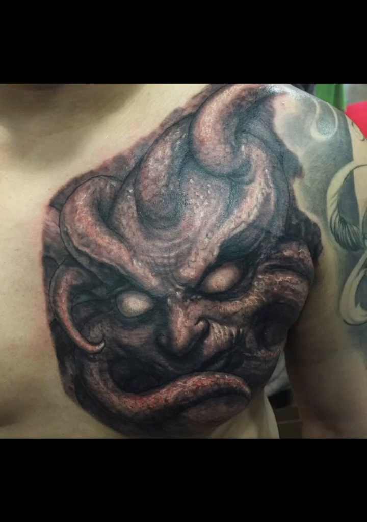 Demonic face with tentacles realism tattoo by Paul Booth