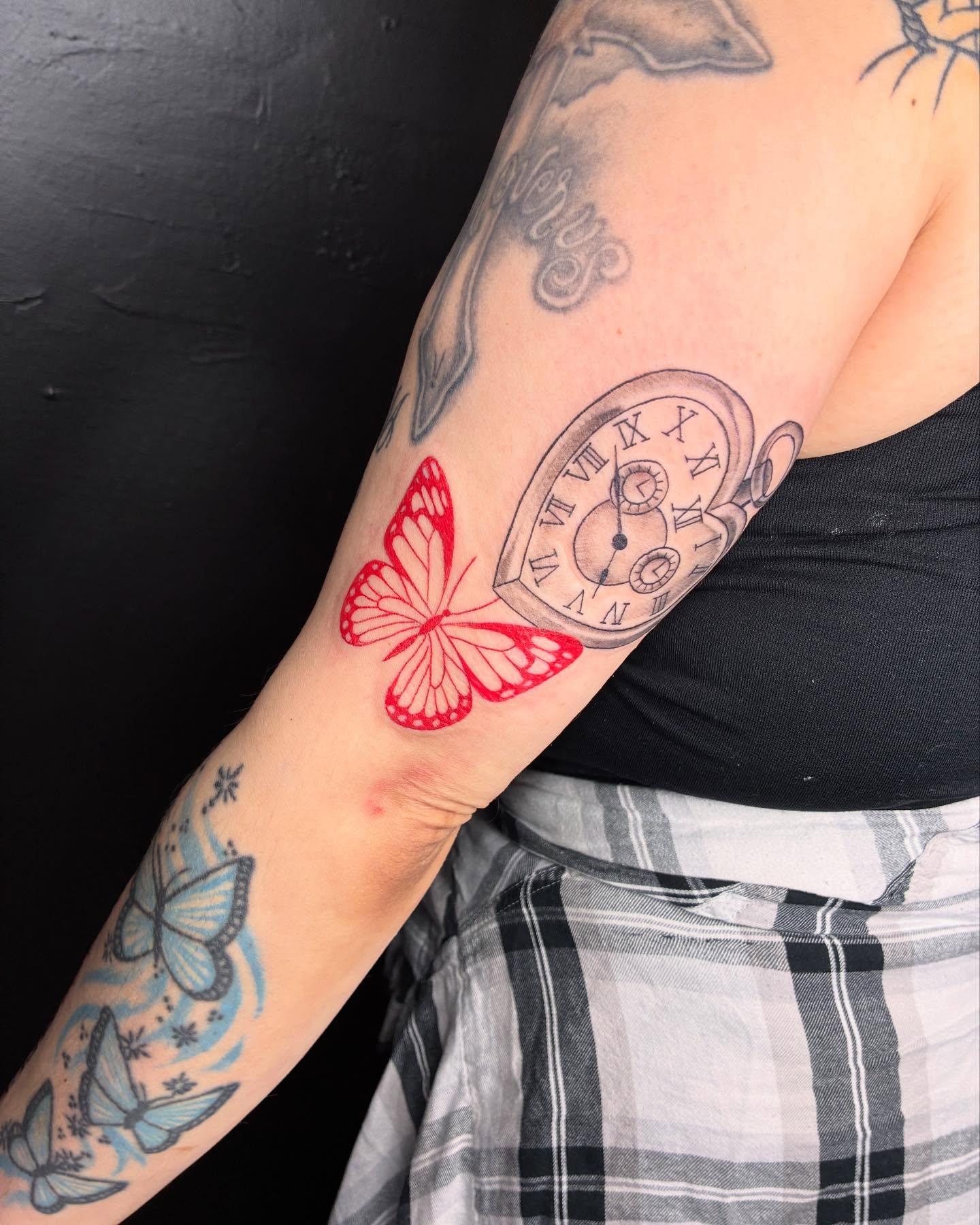 Clock and butterfly realism tattoo on the forearm by Kat π