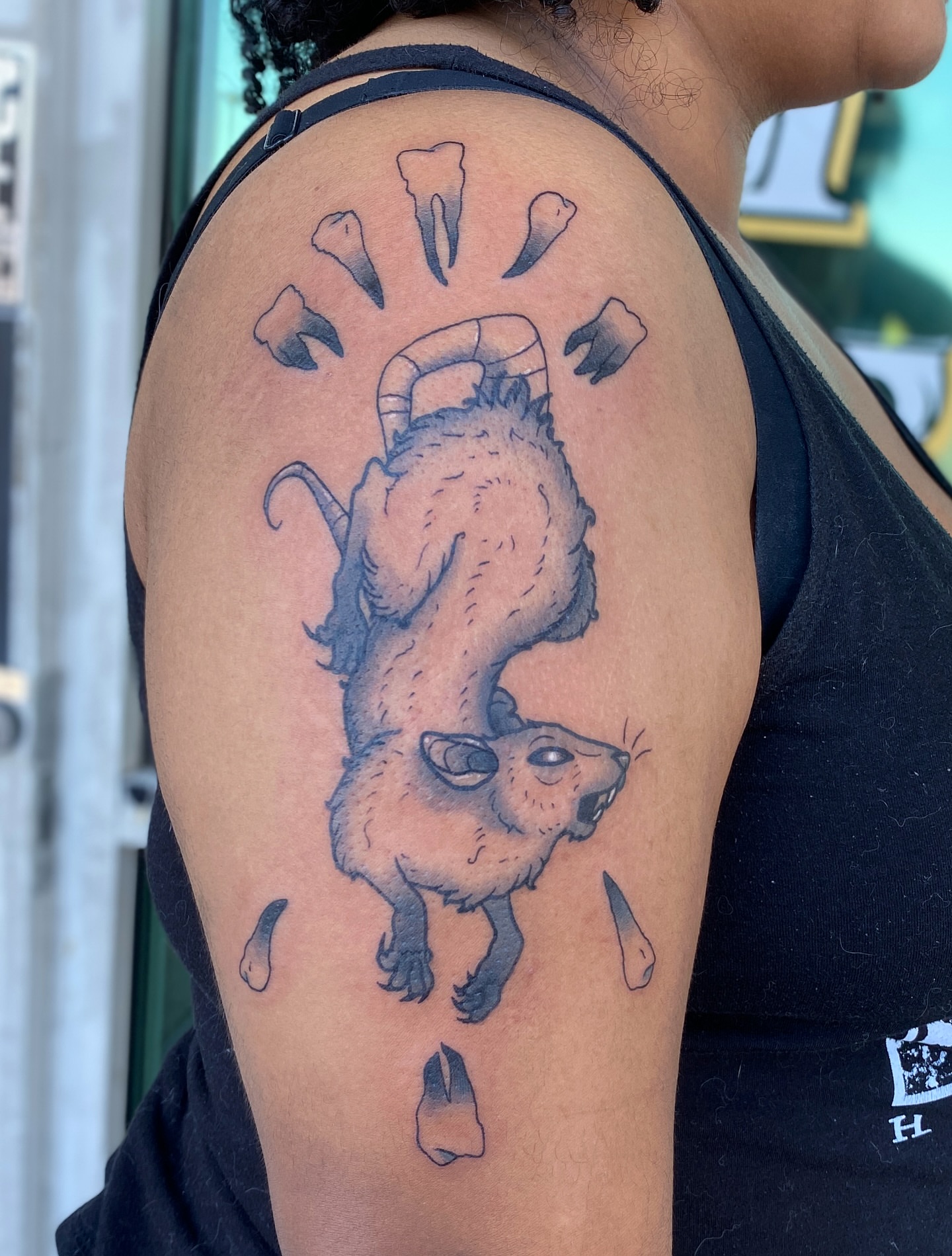 Rat with teeth black and grey tattoo on the shoulder by Elliot Jaye Valentine