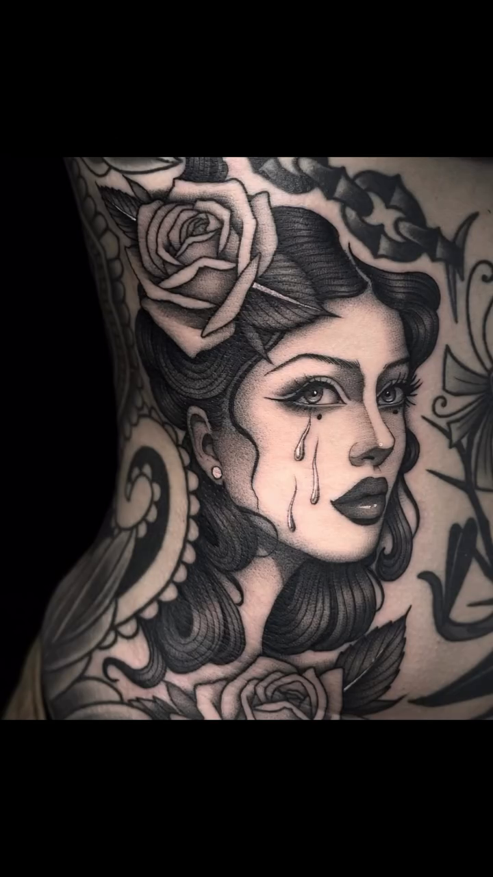 Woman with roses and tears realism tattoo by Luna Lucero