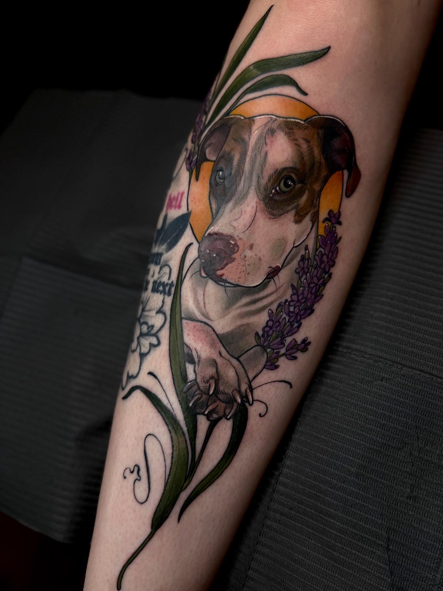 Dog with lavender realism tattoo on the forearm by Rachael Shelly
