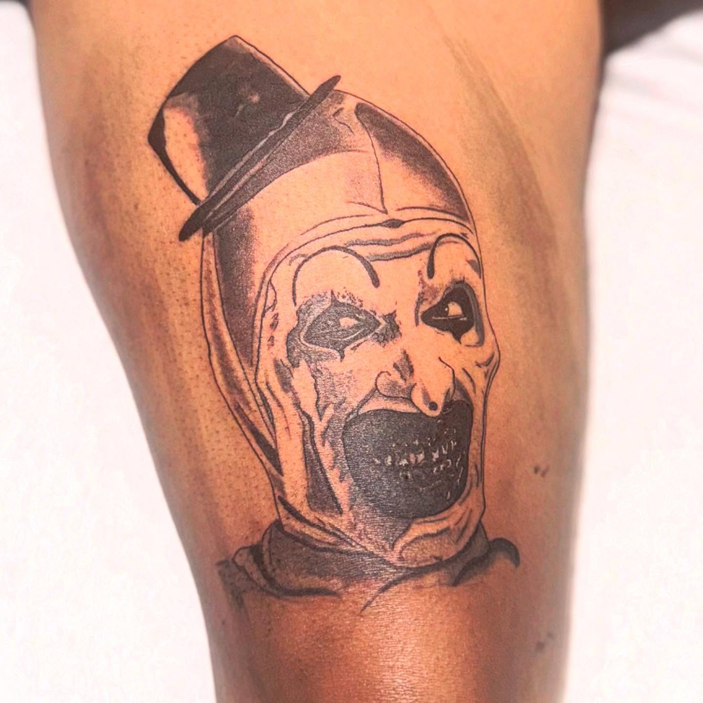 Clown mask black and grey tattoo on the forearm by Noir