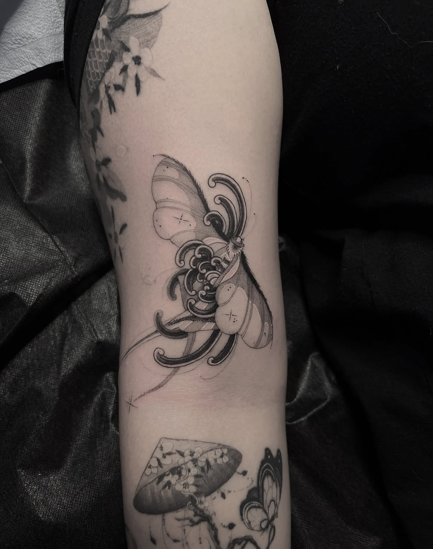Butterfly black and grey tattoo on the forearm by Joshua Hung, Alhambra, California