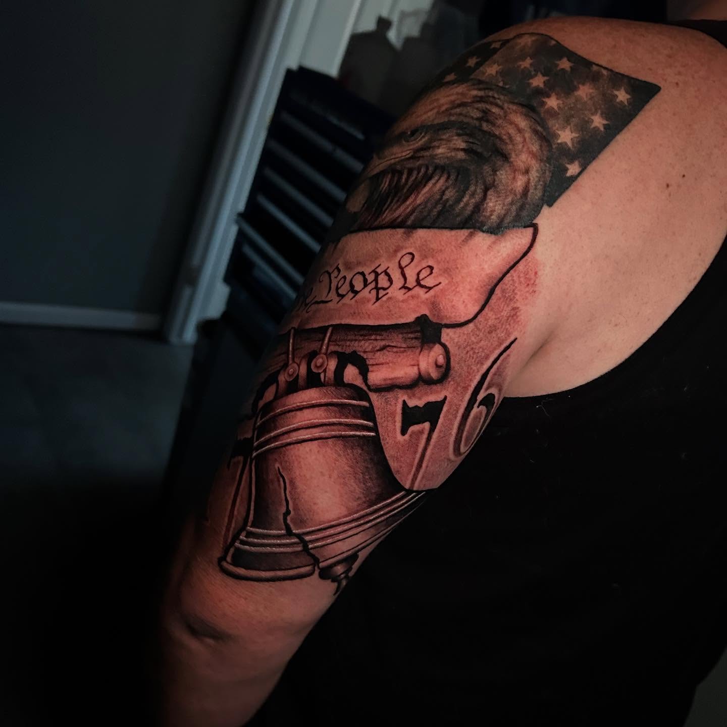 Bell and eagle American traditional tattoo on the shoulder by Adrian Michigan Tattoo Artist
