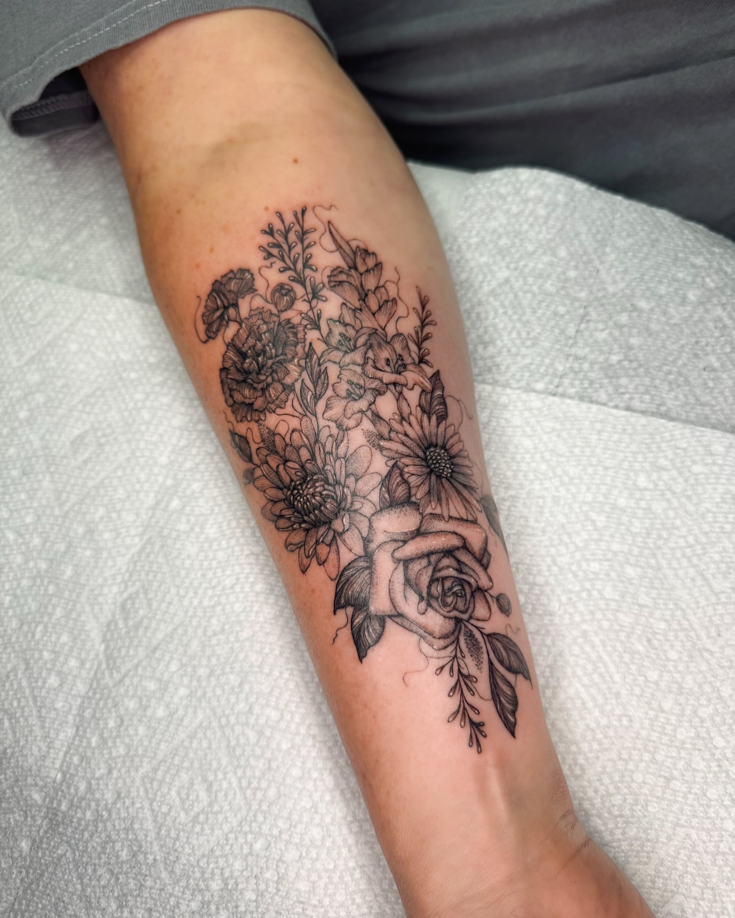 Floral bouquet black and grey tattoo on the forearm by Natasha Rachel Fineline Tattoos Nashville