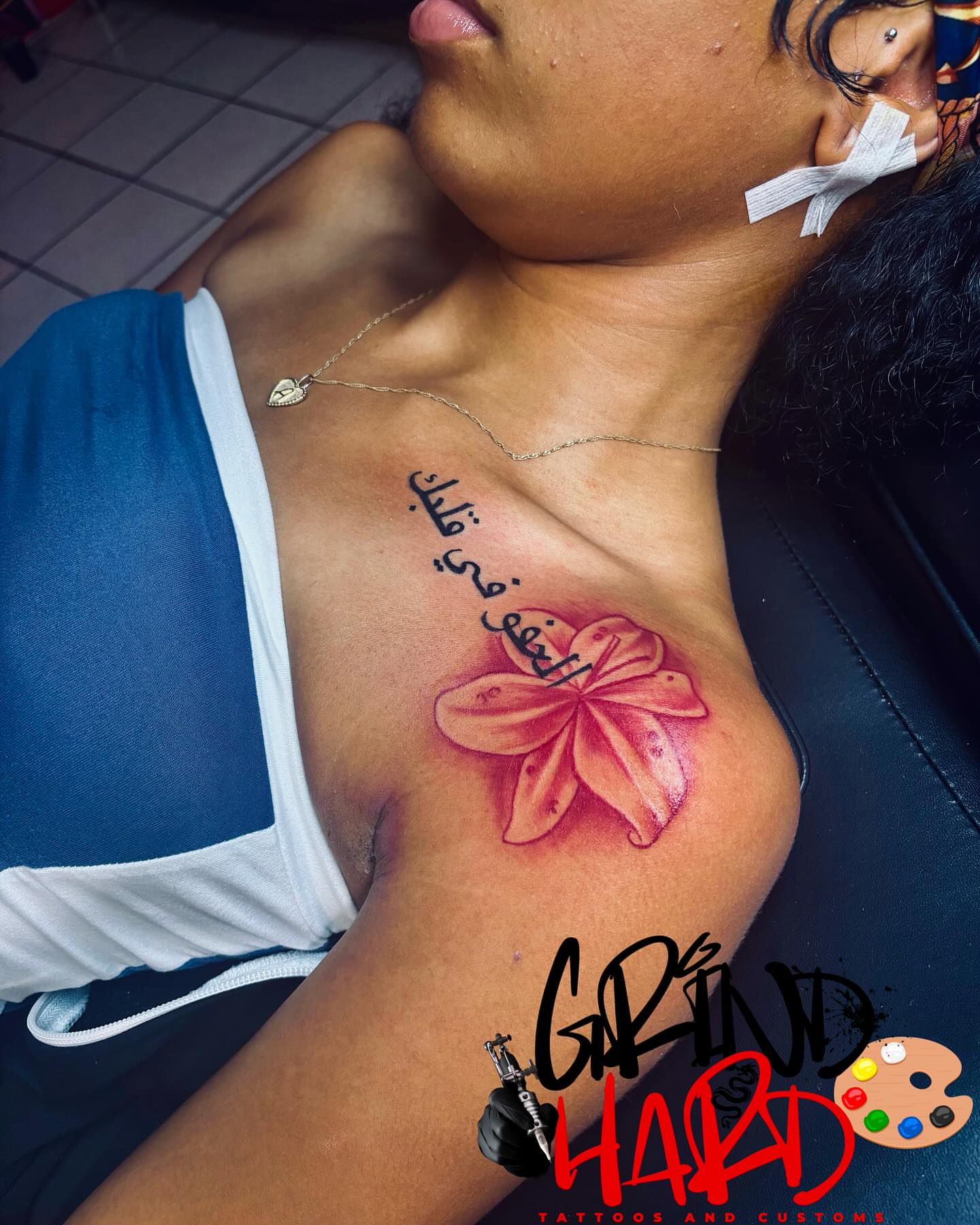 Flower and Arabic text realism tattoo on the chest by GrindHard Quen