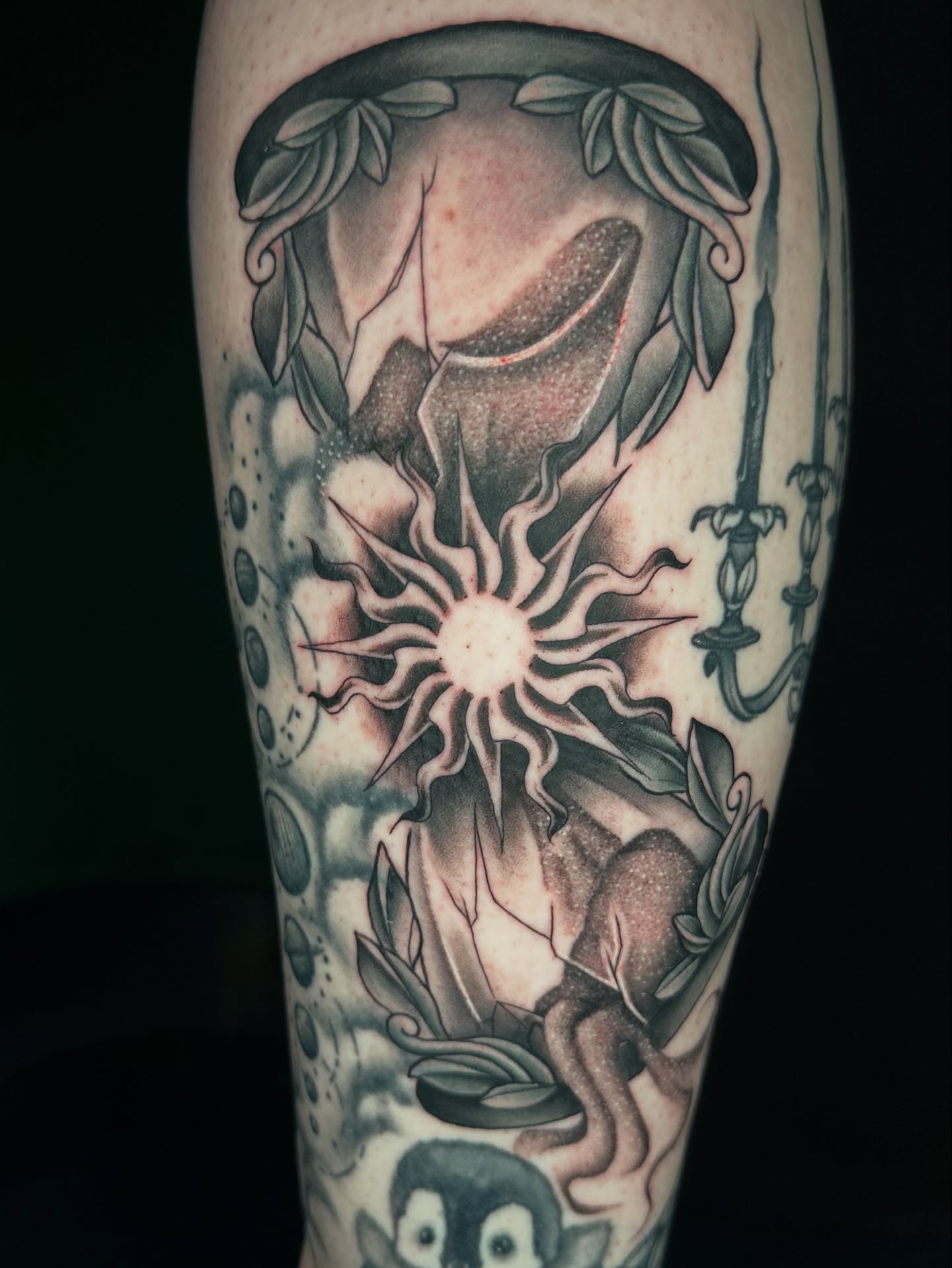 Skull and sun dark realism tattoo on the forearm by Sam Minneci