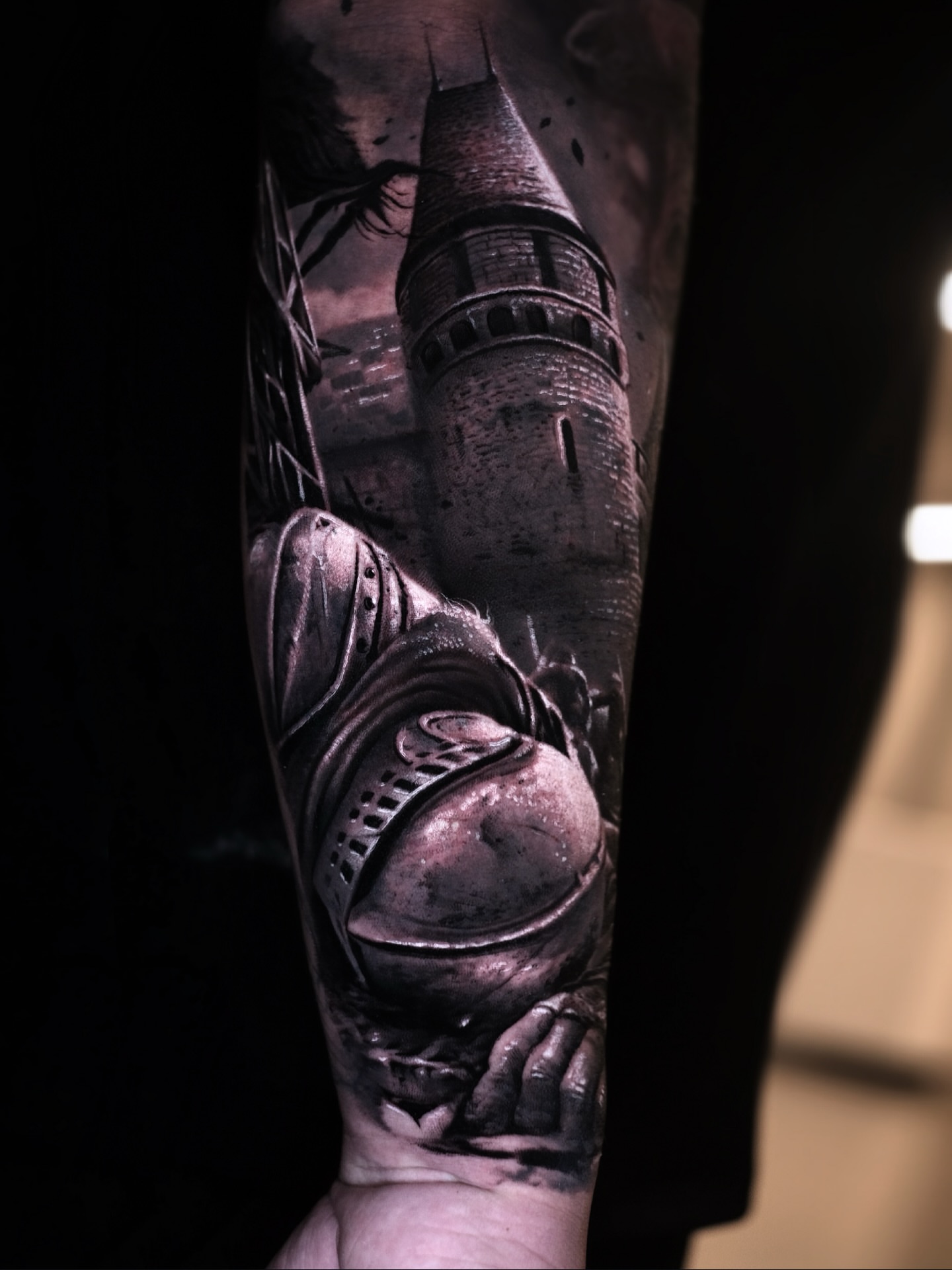 Castle and knight helmet realism tattoo on the forearm by Anton Martiushev