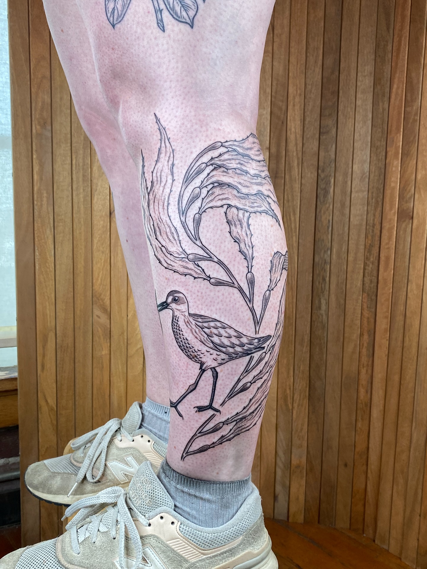 Bird and branches dotwork tattoo on the leg by Avery Kane
