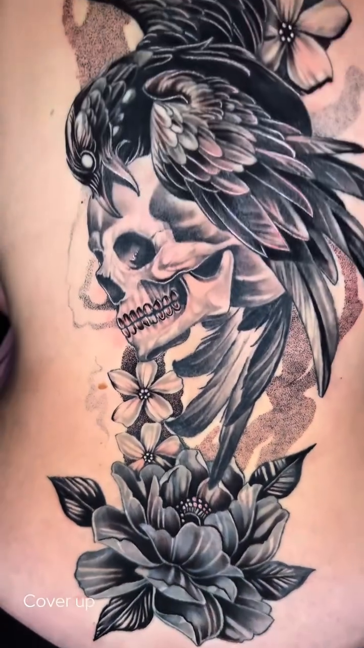 Skull and raven with flowers realism tattoo by Travis Sleeper