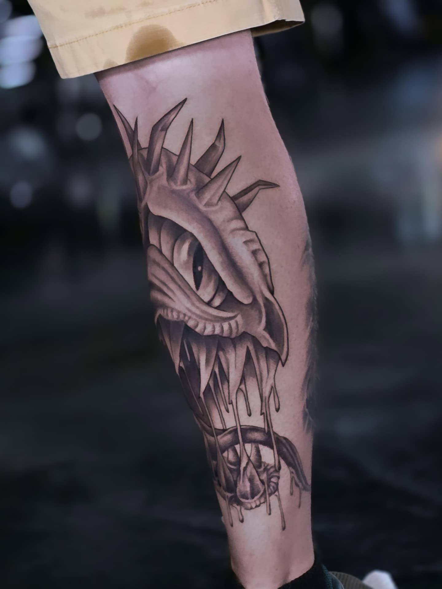 Dripping skull dark realism tattoo on the forearm by Jake Barney