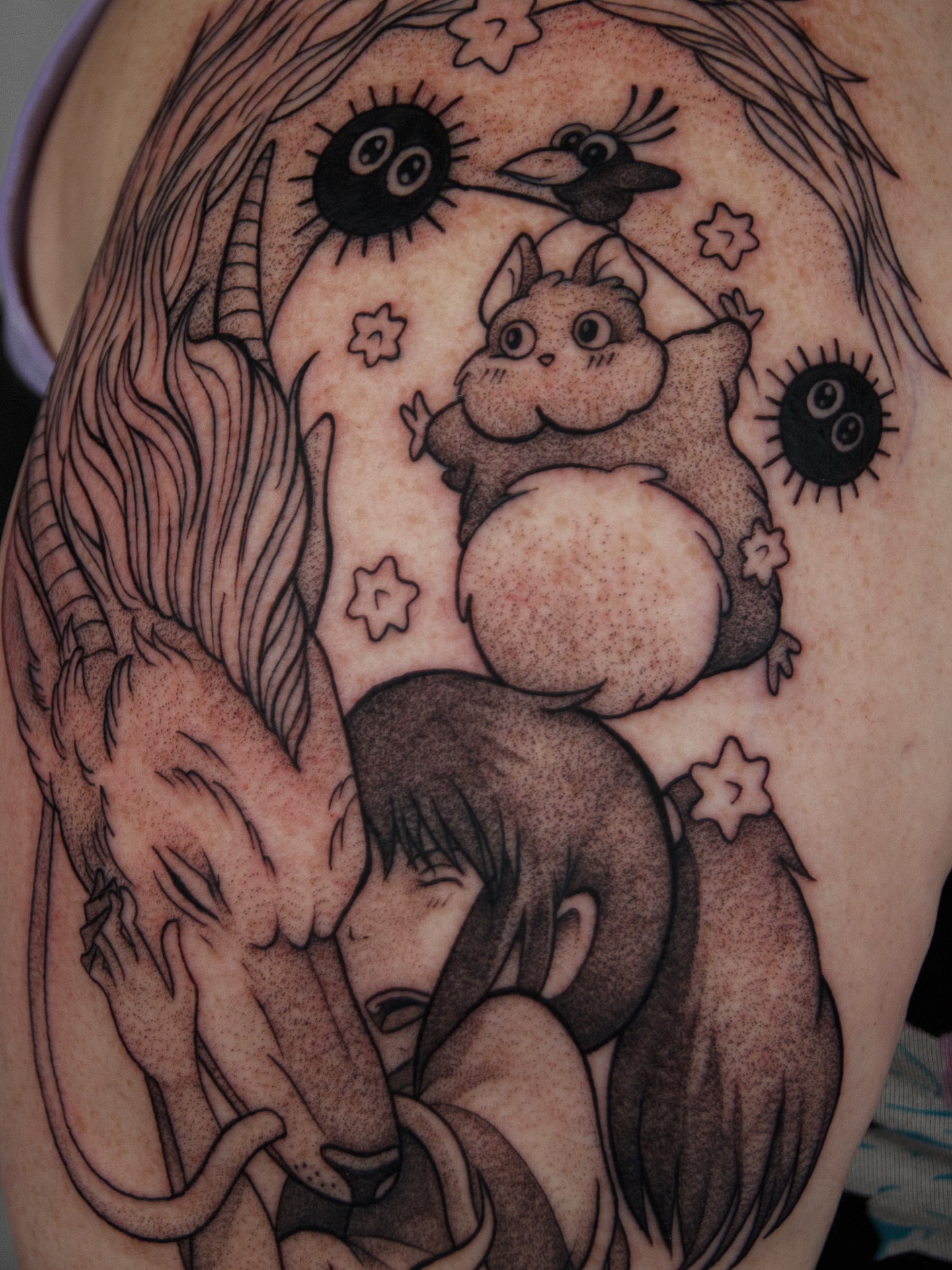 Mythical creature and cat dotwork tattoo on the shoulder by caliope yiannos