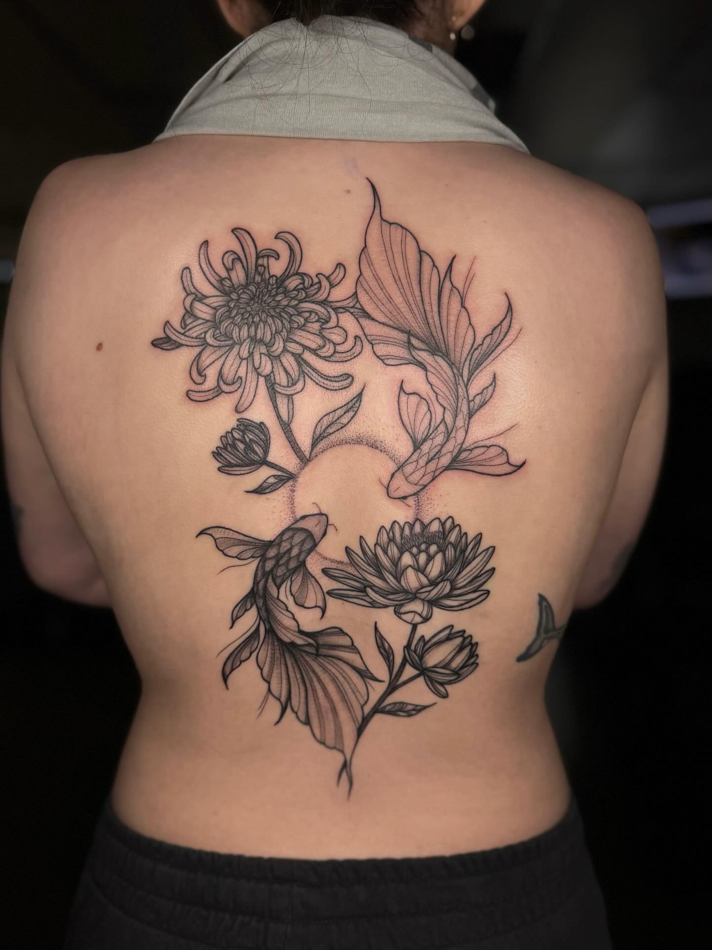 Koi fish and chrysanthemums dotwork tattoo on the back by Koko