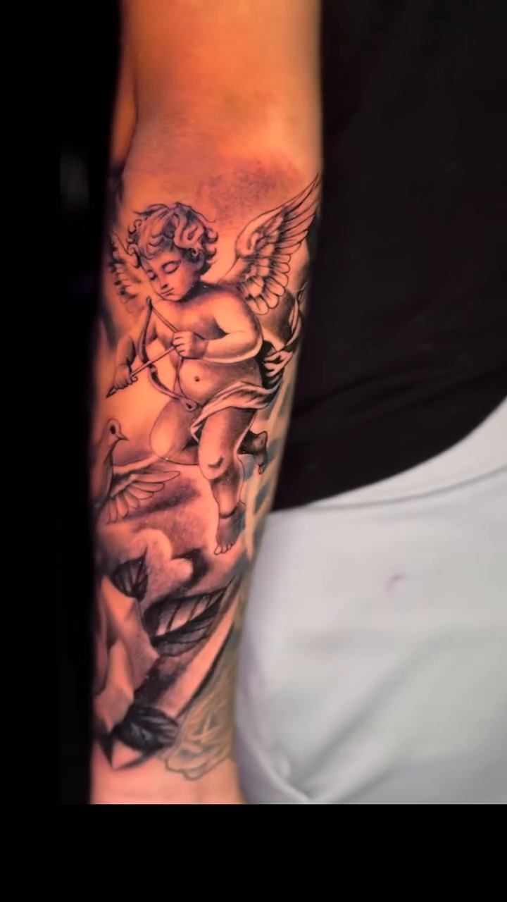 Cherub, dove, and rose realism tattoo by 📍 Austin