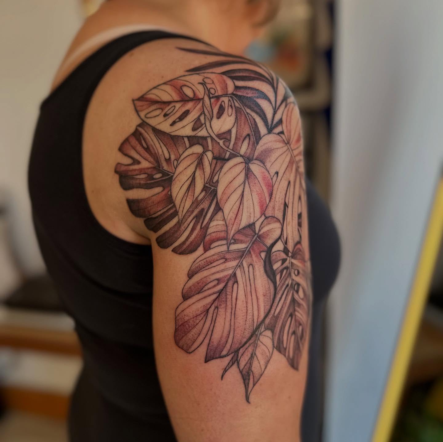 Tropical leaves realism tattoo on the shoulder by Abigail Townsend