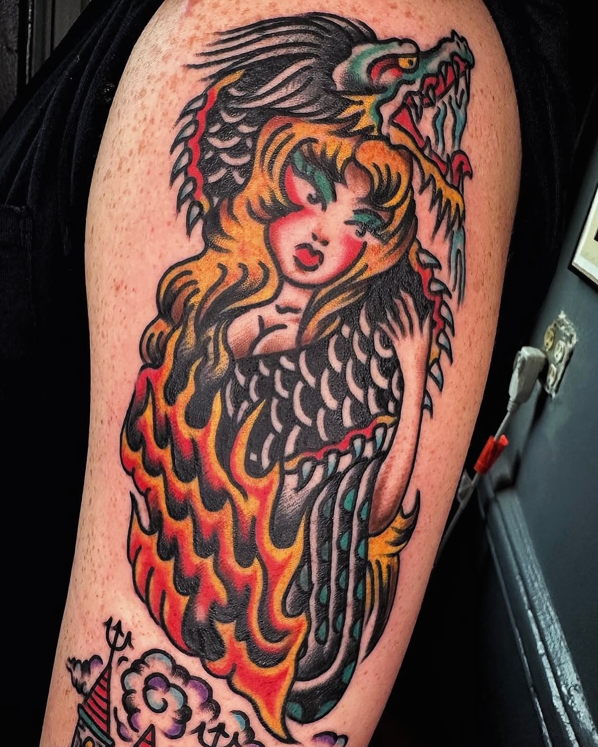 Mermaid American traditional tattoo on the upper arm by Tony Kaplan