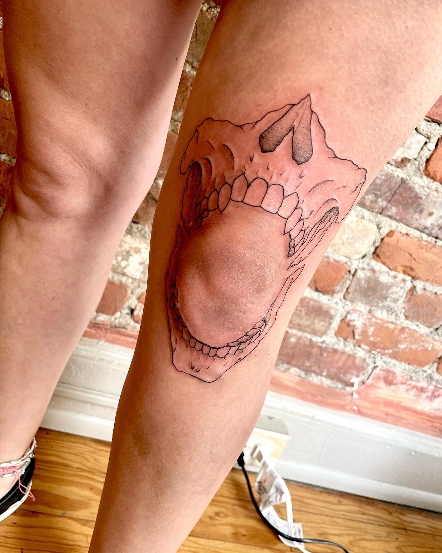 Skull black and grey tattoo on the thigh by madison, Cincinnati